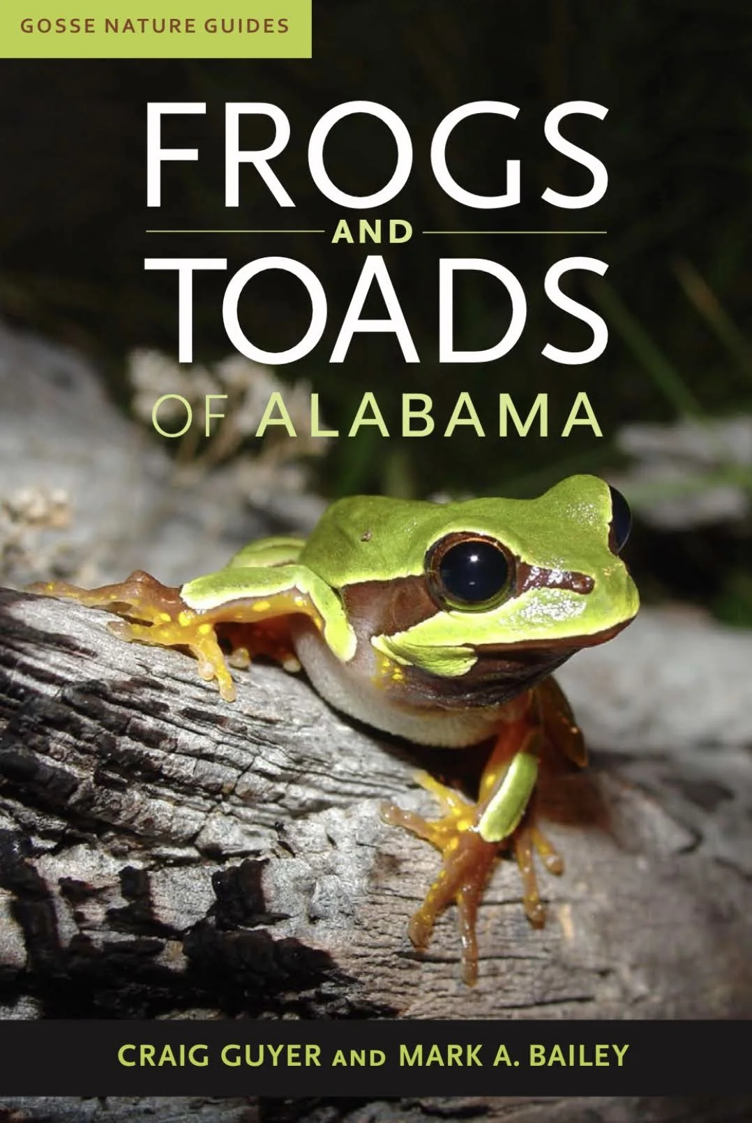 Cover of a book titled 'Frogs and Toads of Alabama' featuring a close-up photograph of a green tree frog perched on a log.