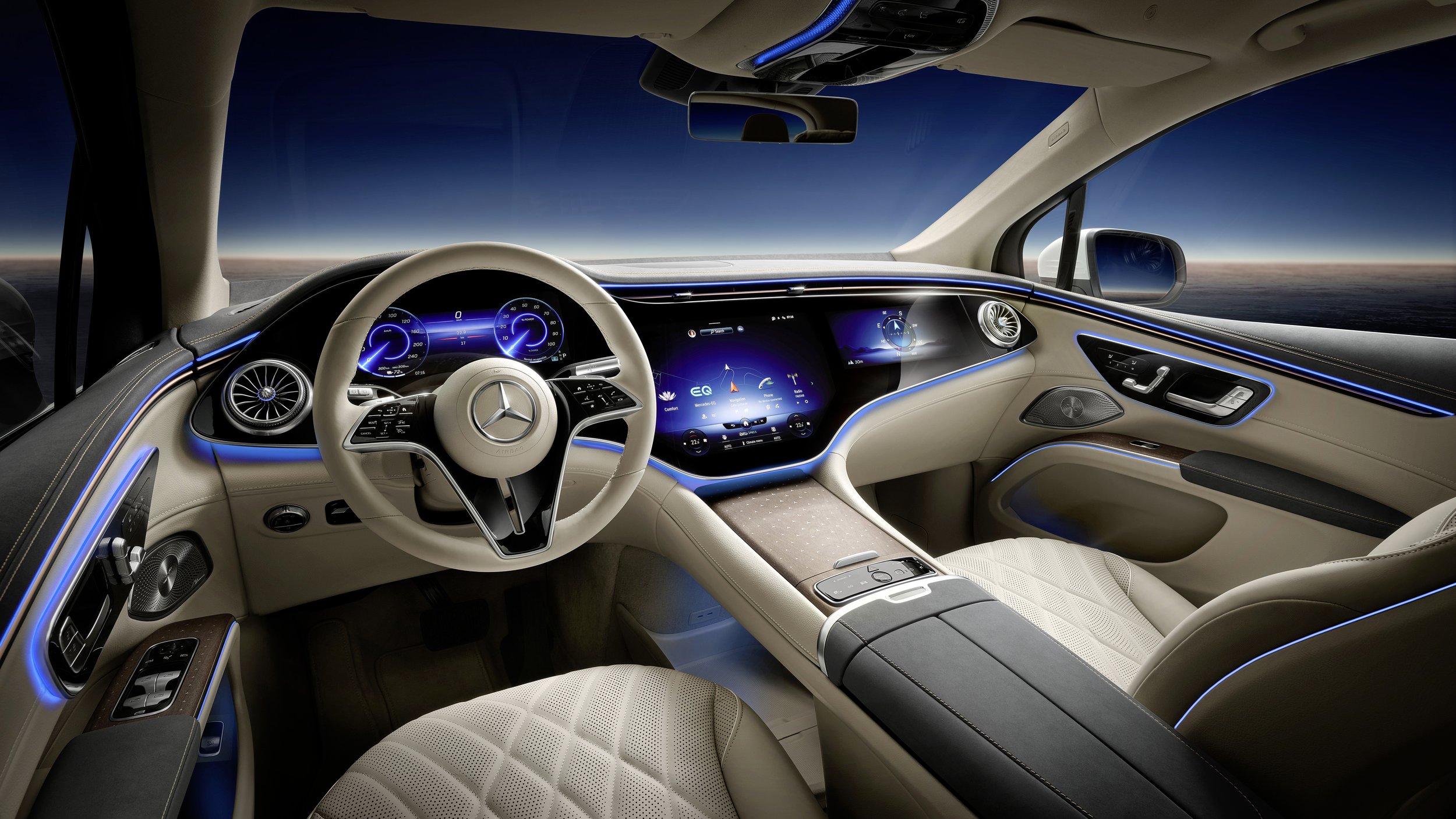 The interior of a Mercedes-Benz EQS SUV with a digital dashboard, beige leather seats, ambient blue lighting, and a panoramic view of the sky through the windshield.