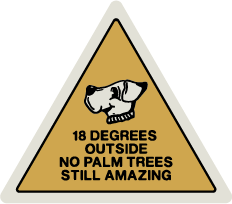 Panneau de signalisation triangulaire jaune avec une tête de tigre, indiquant une température de 18 degrés, mentionnant 'Dehors, pas d'arbres de palmier, toujours étonnant'.