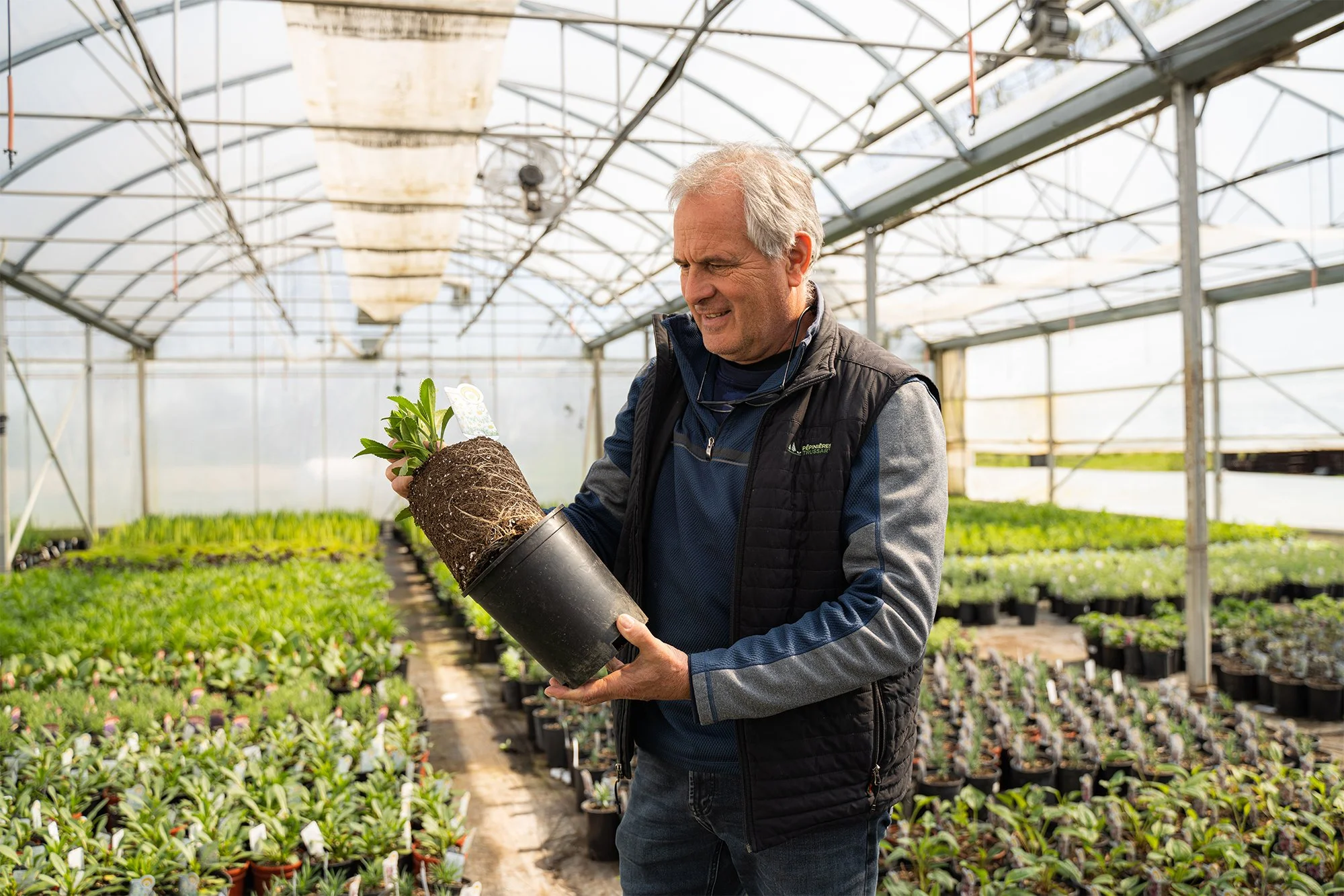 A man holding a potted plant
