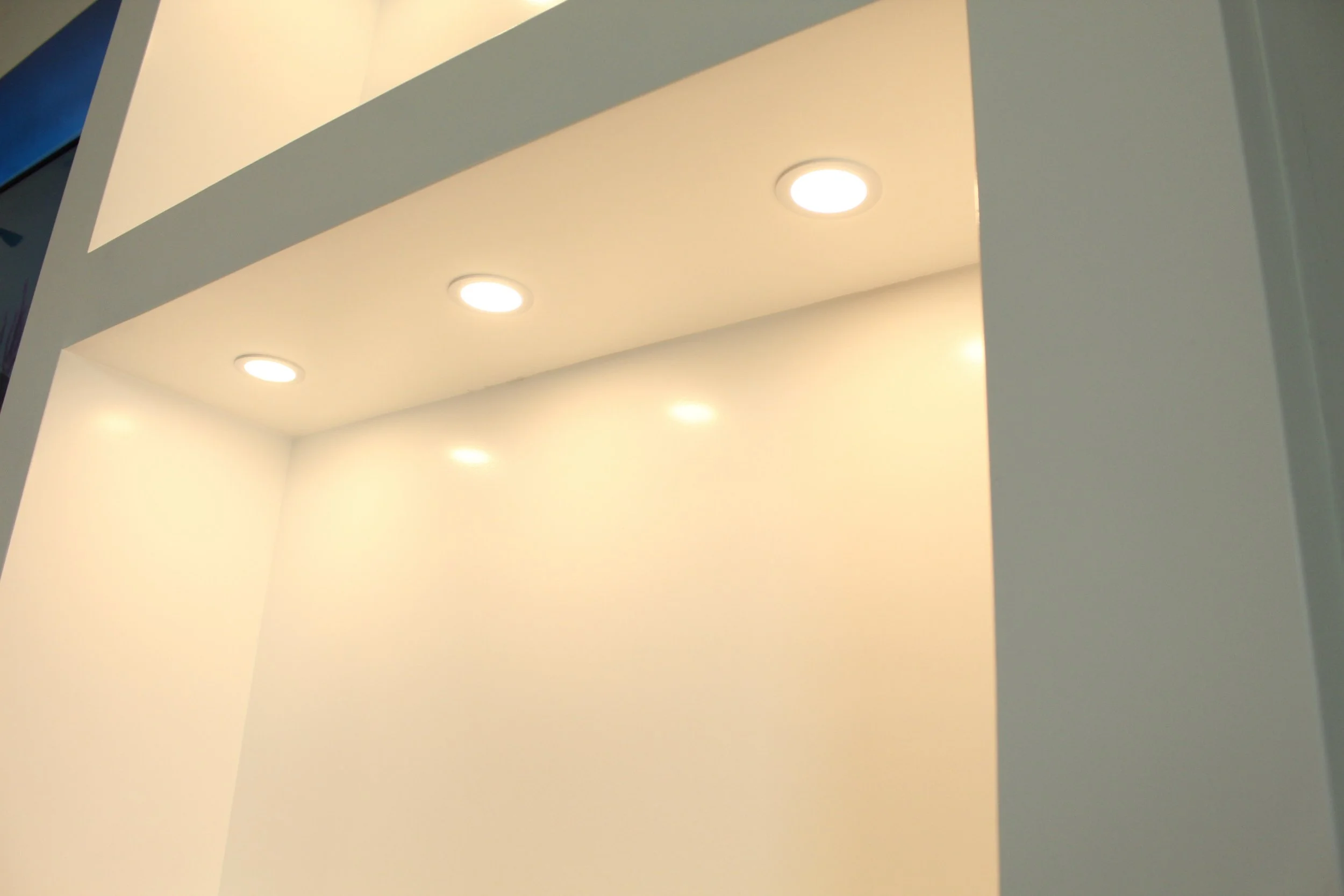 Ceiling with embedded round recessed lights in a modern interior.