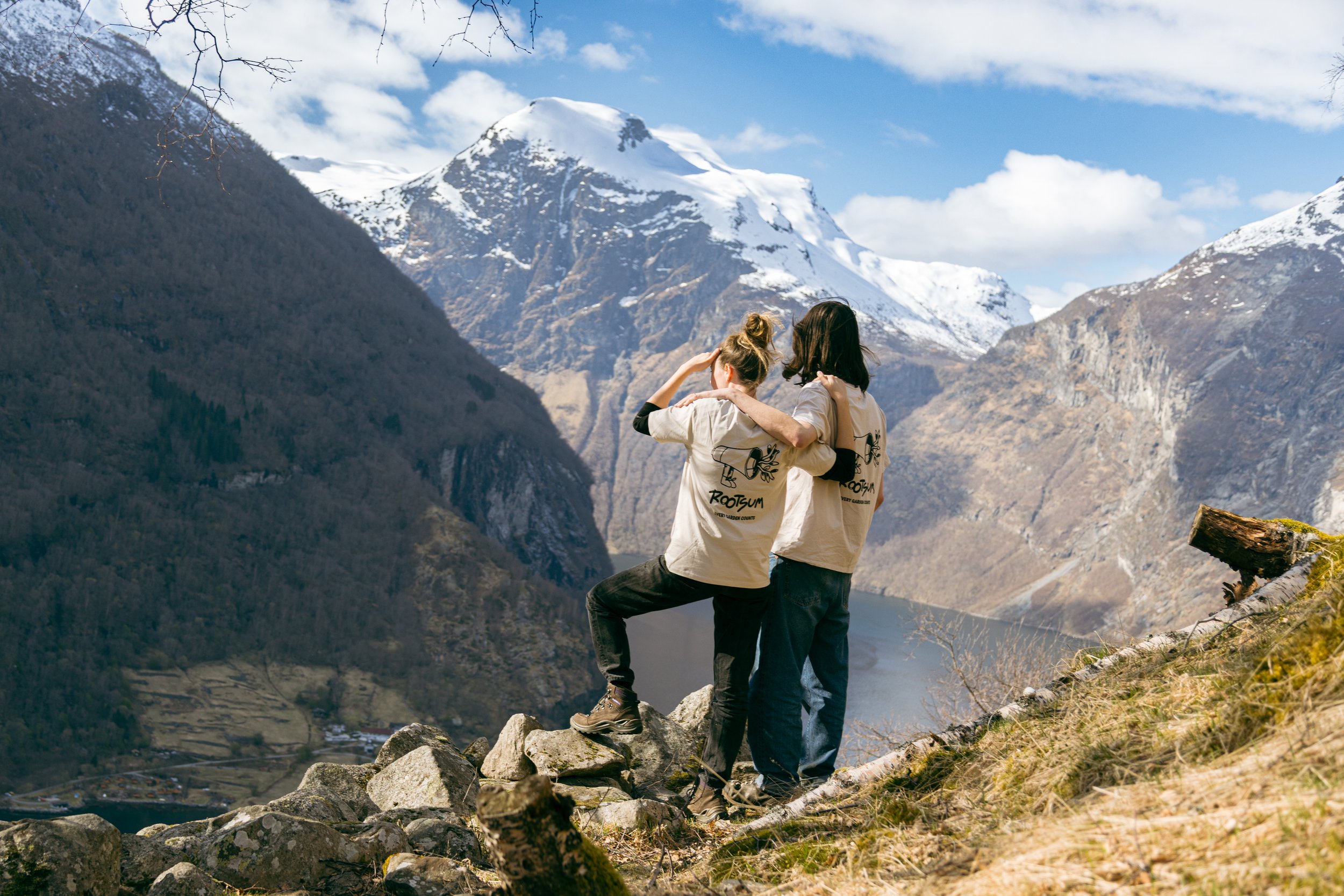 Twyla Mergan and Wouter Vergote, founders of Noisy Napkin, a creative studio for the good side, standing above the fjords in Geiranger, Norway.