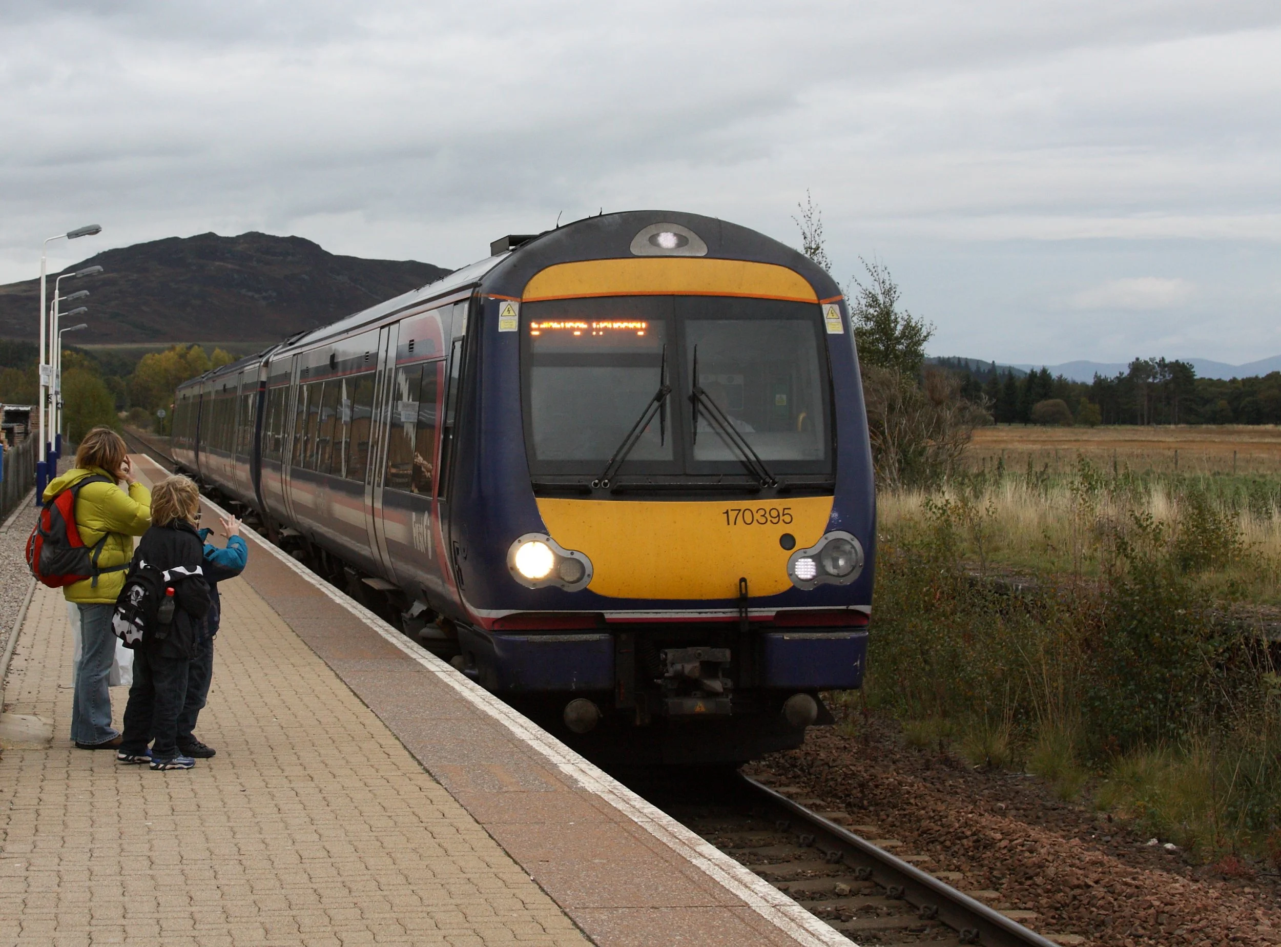 A ScotRail Class 170 train at Newtonmore station on the Highland Main Line — the station is at the end of the street, a 5-minute walk from the hostel.