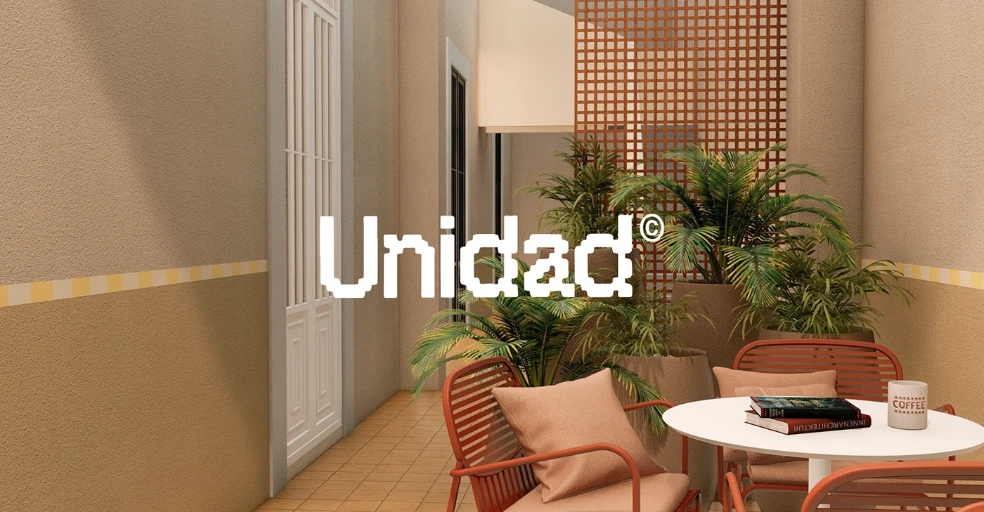 Ático con plantas verdes, sillas de mimbre con cojines beige y una mesa blanca con libros y una taza de café, paredes beige y detalles decorativos en tonos cálidos.