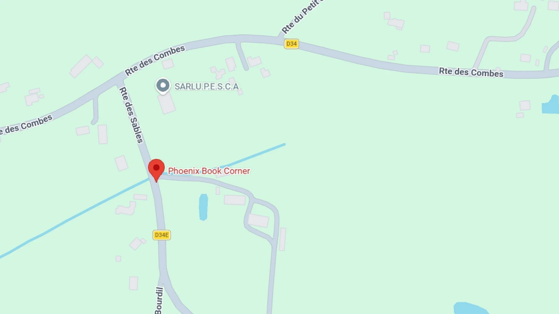 Map showing roads and locations with a pin at Phoenix Book Corner near Rue des Sables in a rural area.