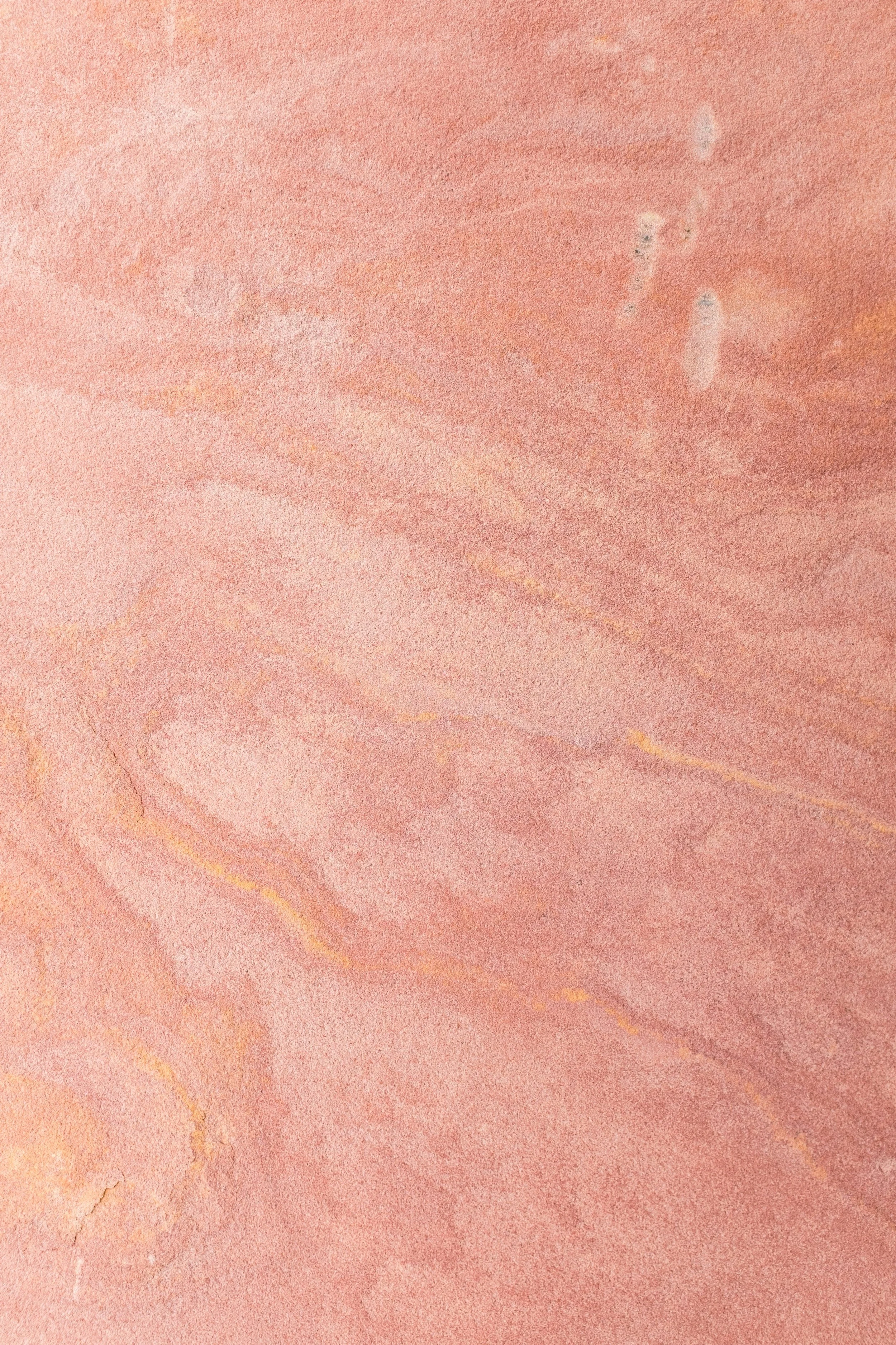 Pink and beige marble texture with natural veining patterns.