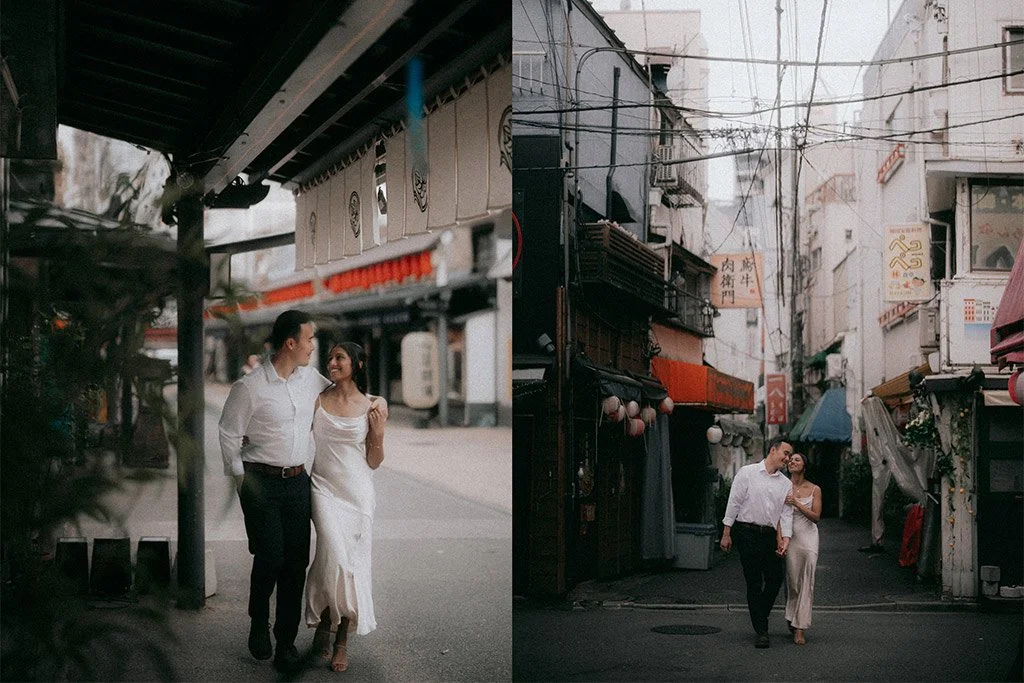 A couple walking together on an empty street in an urban area with Asian signage and narrow alleyways, sharing a happy moment.