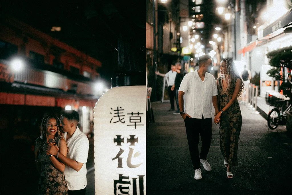 A couple walking and smiling on a city street at night, with bright lights and other people in the background.