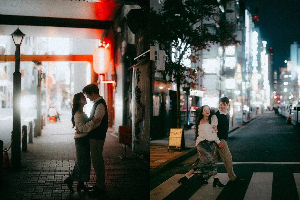 Two couples standing close together on a city street at night, with illuminated buildings and signs in the background. One couple is in front of a lit entrance, while the other is crossing a street.