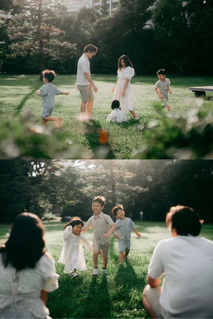 Children playing and relaxing in a park on a sunny day, with trees and grass in the background.