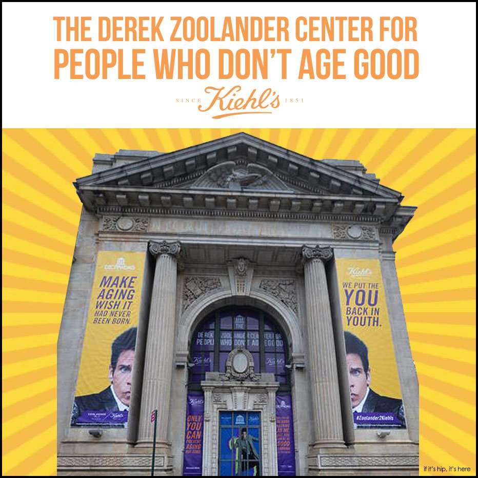 Facade of the Derek Zoolander Center for People Who Don't Age Good, with large banners featuring a male model and bright yellow background with rays, promoting anti-aging products and youth restoration.