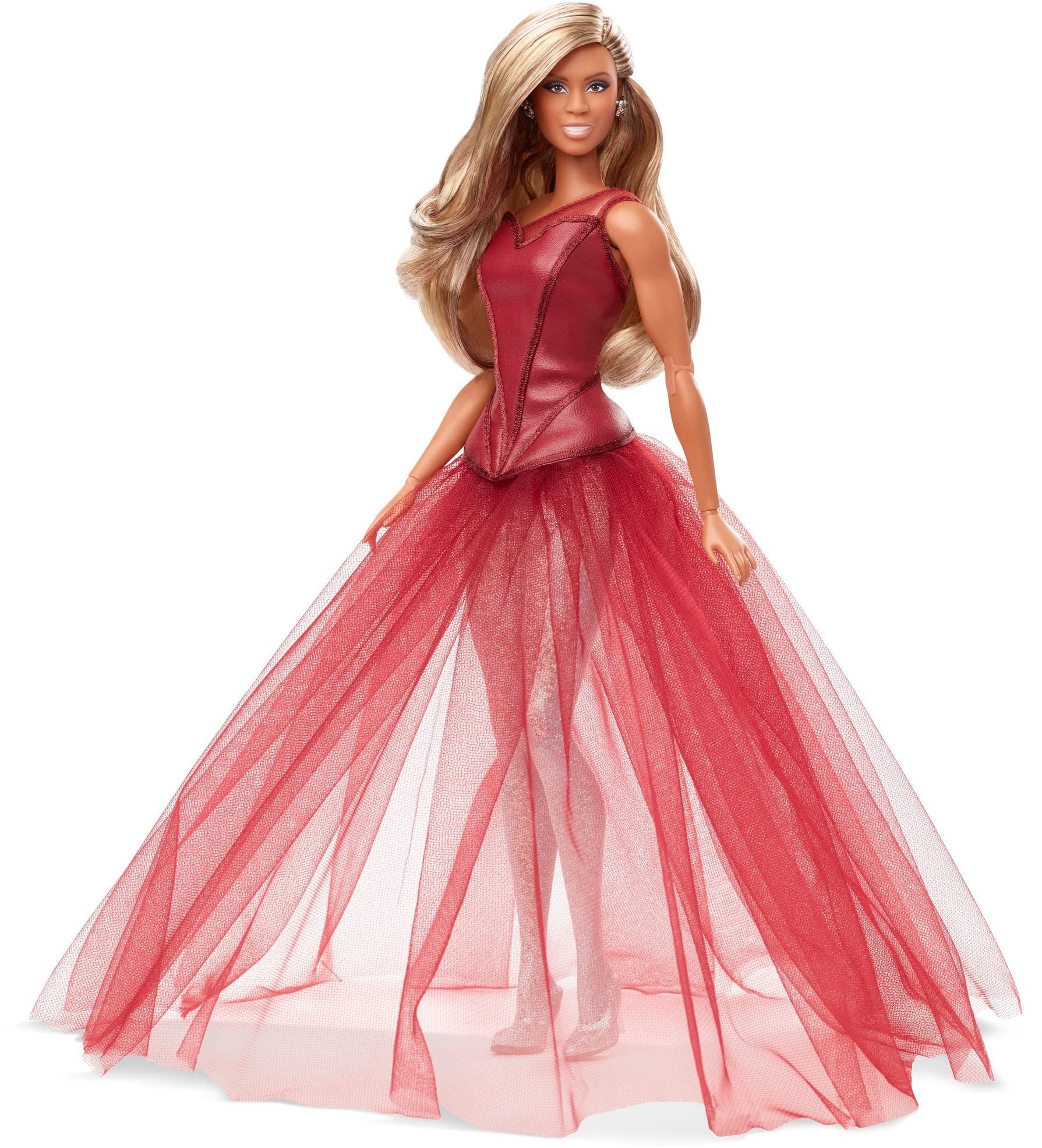 A woman with long blonde hair wearing a red, strapless leather top and a voluminous red tulle skirt.