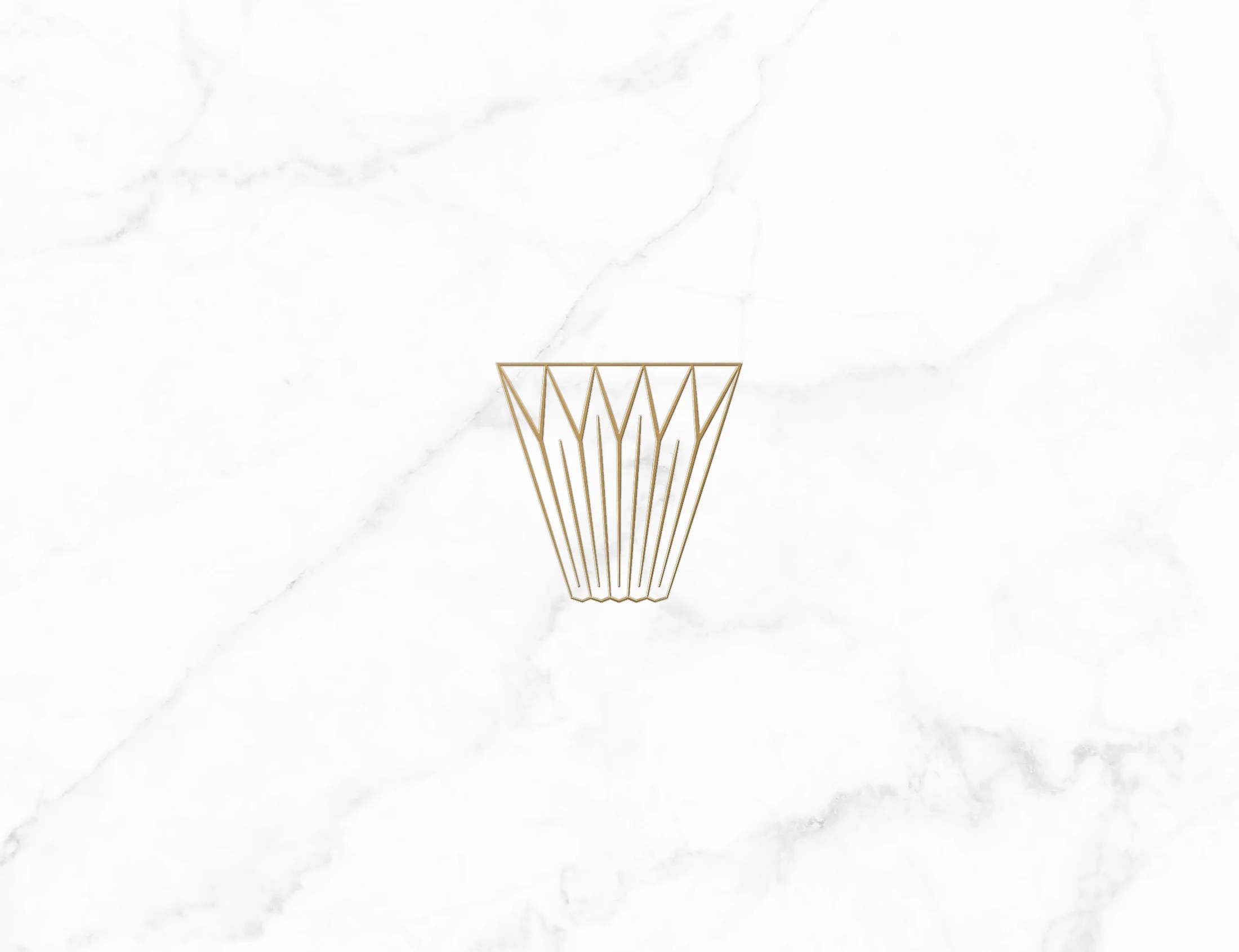 A gold wire basket against a white marble background.
