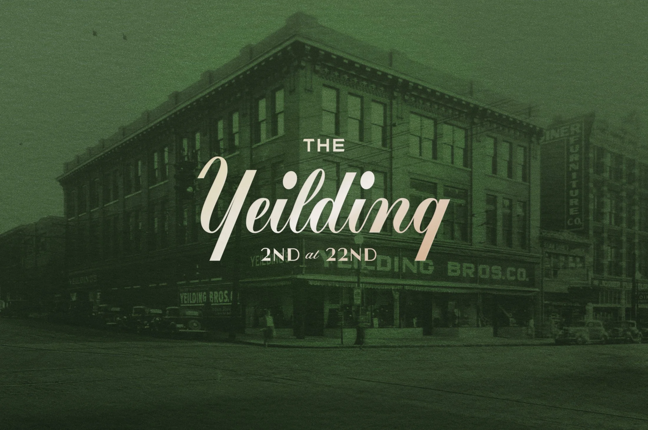 A vintage black and white photograph of a city street with a large building on the corner labeled 'Yelding Bros Co.' The text 'The Yelding 2nd at 22nd' is overlaid on the image.