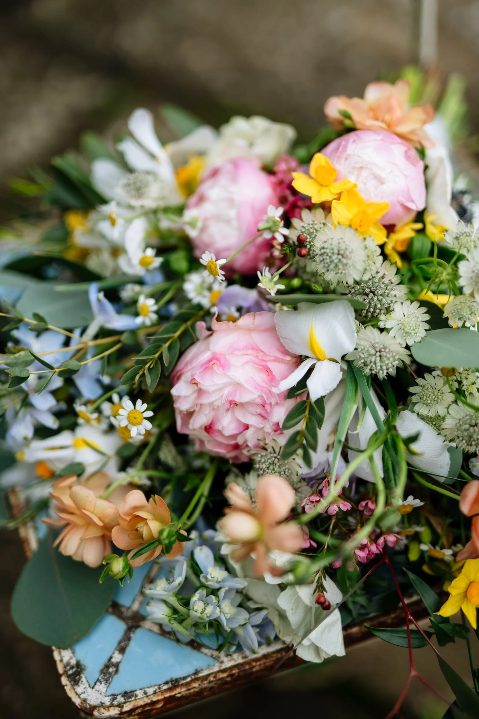 Colourful pastel seasonal wedding flowers with pink peonies, white iris and delicate daisies, arranged by The Crafted Garden in North Somerset.