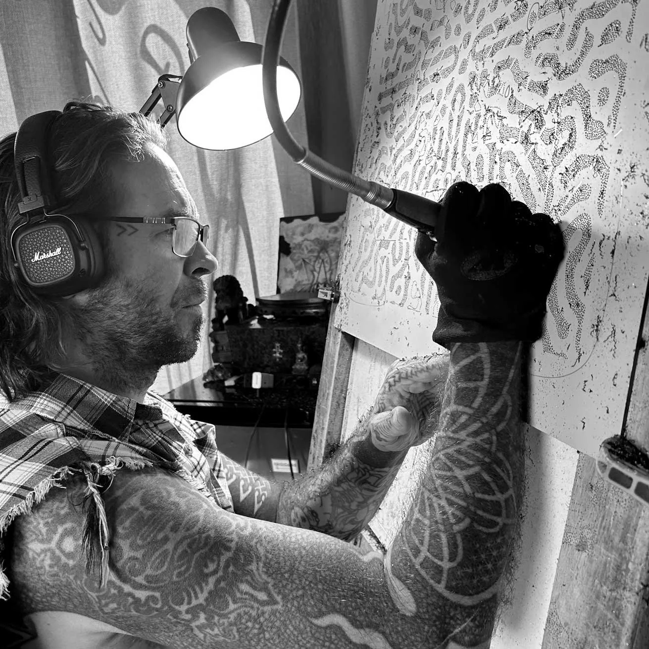 Patrick Hüttlinger hand-drilling a Photonic Pointillism Lightwork, applying the same precision and discipline developed through decades of geometric tattooing.