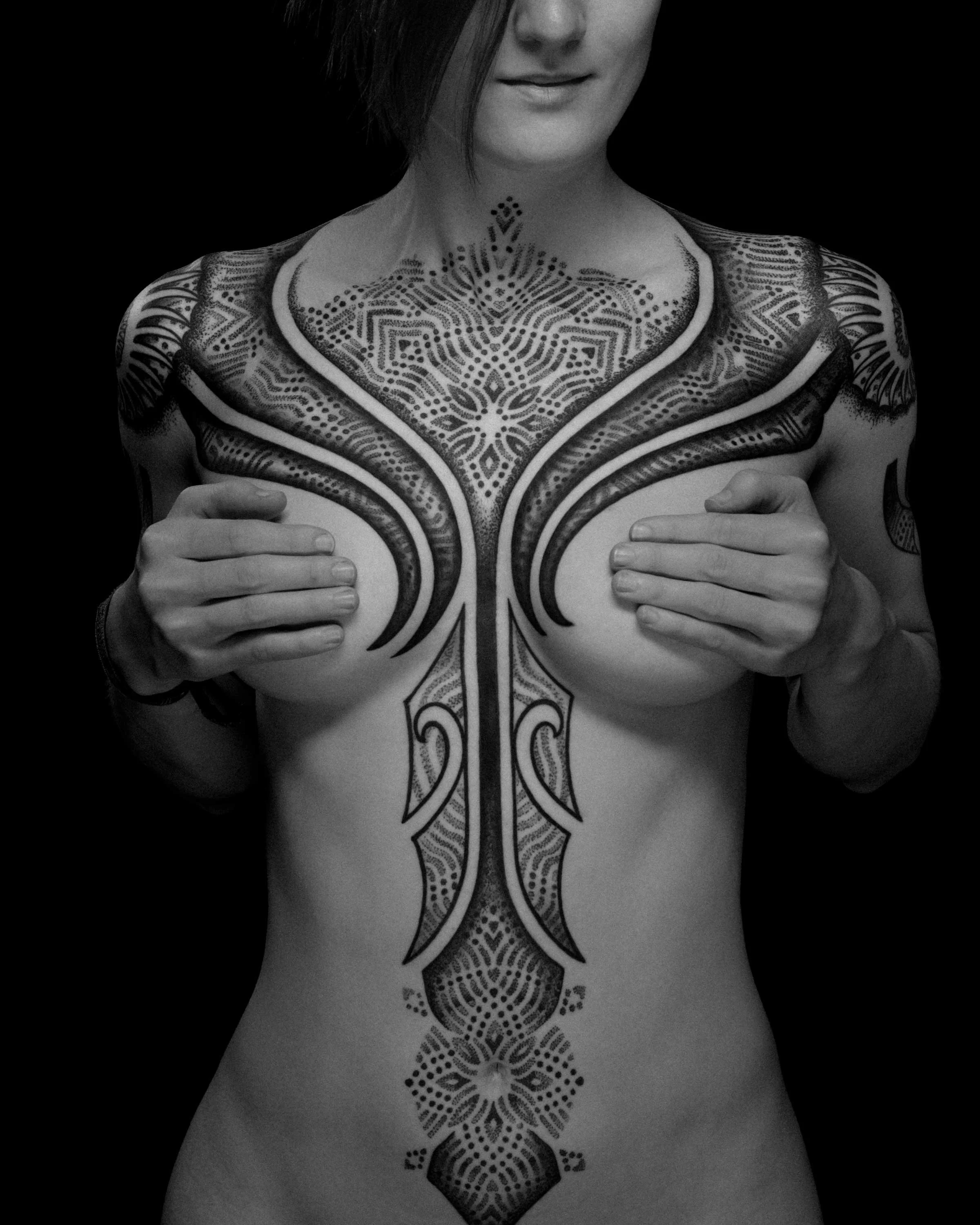 Reaction Diffusion chest and torso tattoo by German tattoo artist Patrick Hüttlinger featuring flowing geometric blackwork inspired by natural growth patterns.