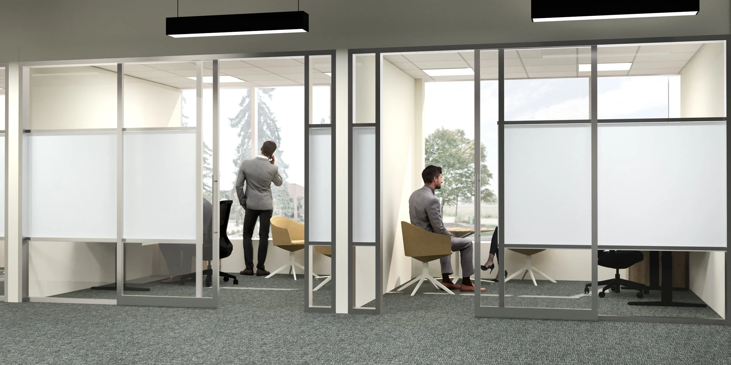 Modern office with glass partition walls, two men in business suits working, one on the phone and the other seated with a laptop, outside view of trees through large windows.