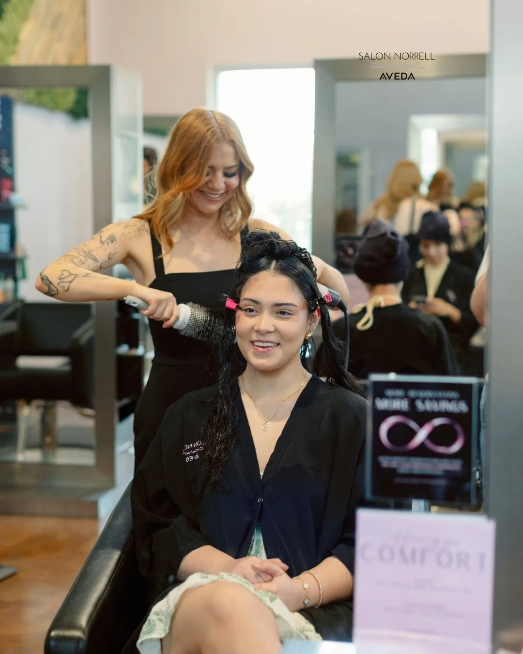 Rose — blonding, vivid color, and layered haircut specialist at Salon Norrell AVEDA in Carrollwood Tampa doing a bouncy blowout