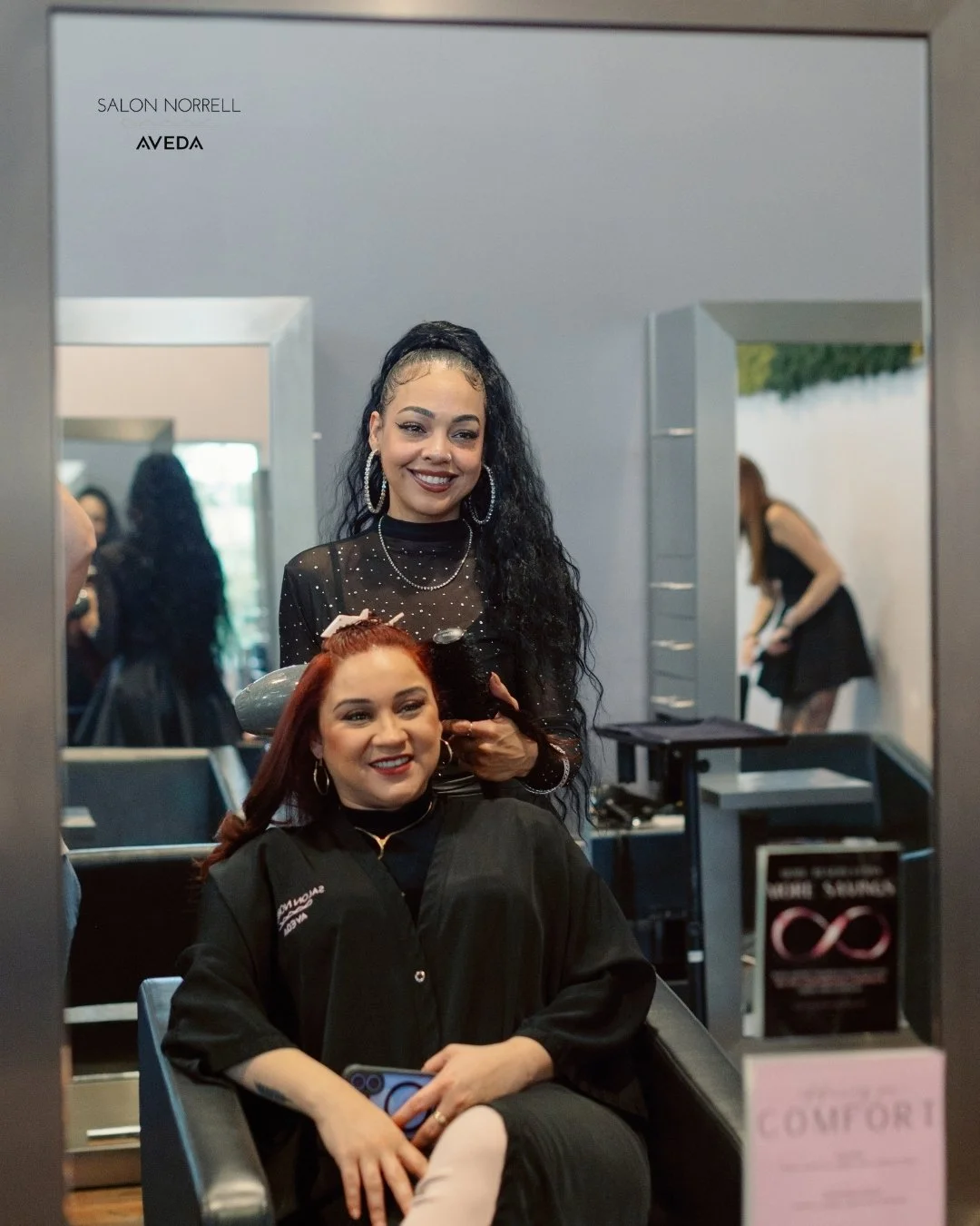 Jesalyn — rich brunette, balayage, and textured hair specialist at Salon Norrell AVEDA in Carrollwood Tampa doing a bouncy blowout
