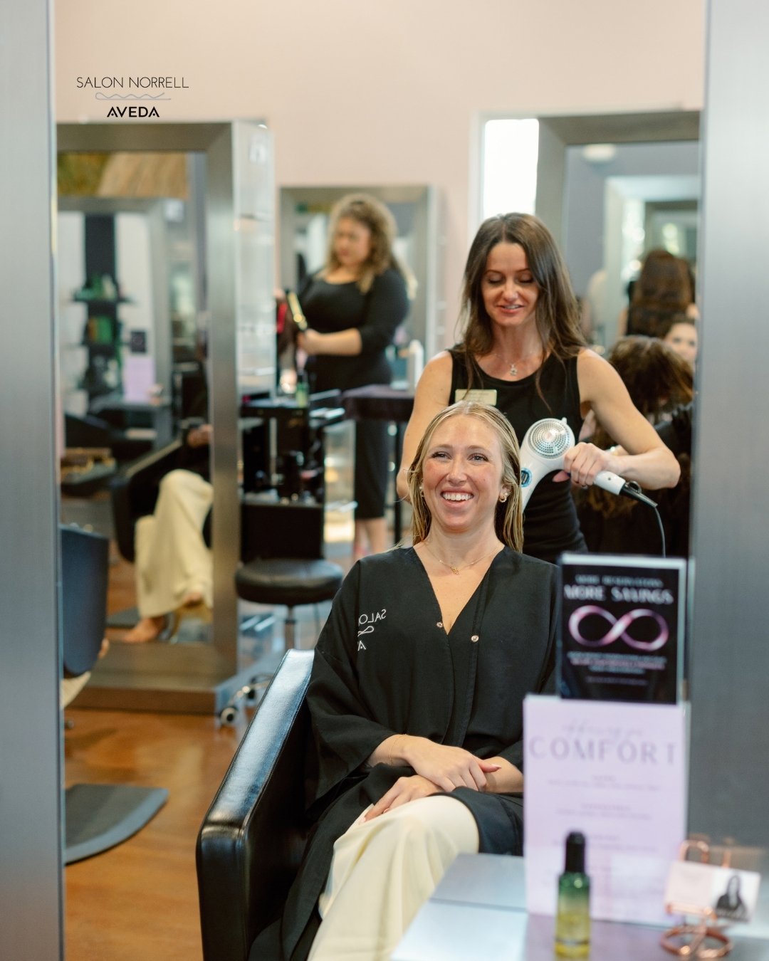 Amberlee — precision cutting, dimensional color, and textured hair specialist at Salon Norrell AVEDA in Carrollwood Tampa doing a bouncy blowout