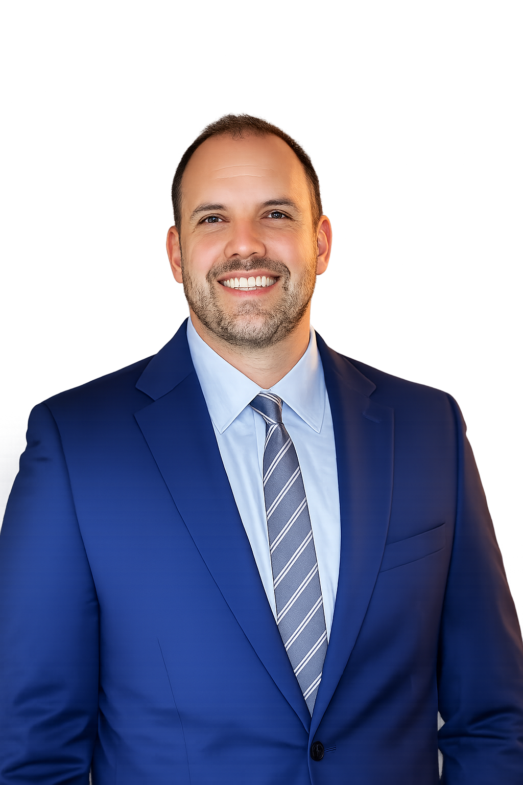 A smiling man in a blue suit and striped tie standing in front of a dark, cityscape background with blue and red lighting.