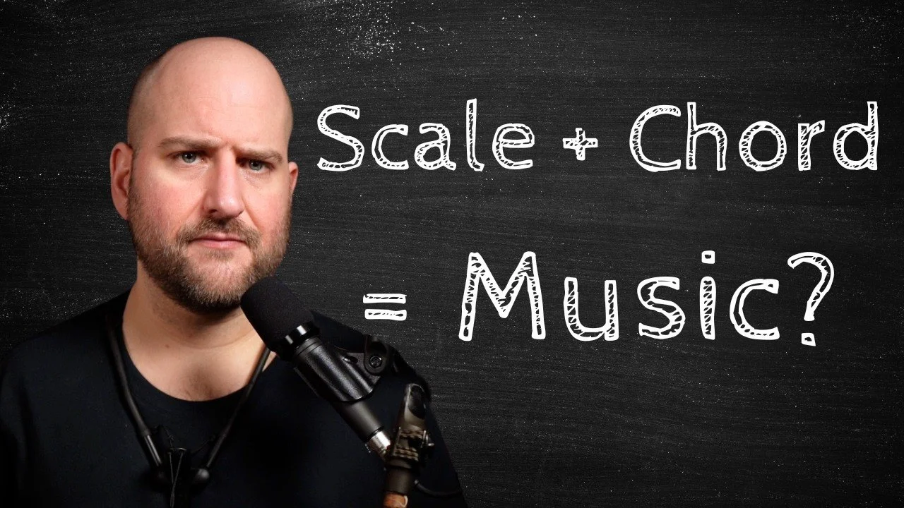 Mike Chillingworth standing against a blackboard with the text 'Scale + Chord = Music?'