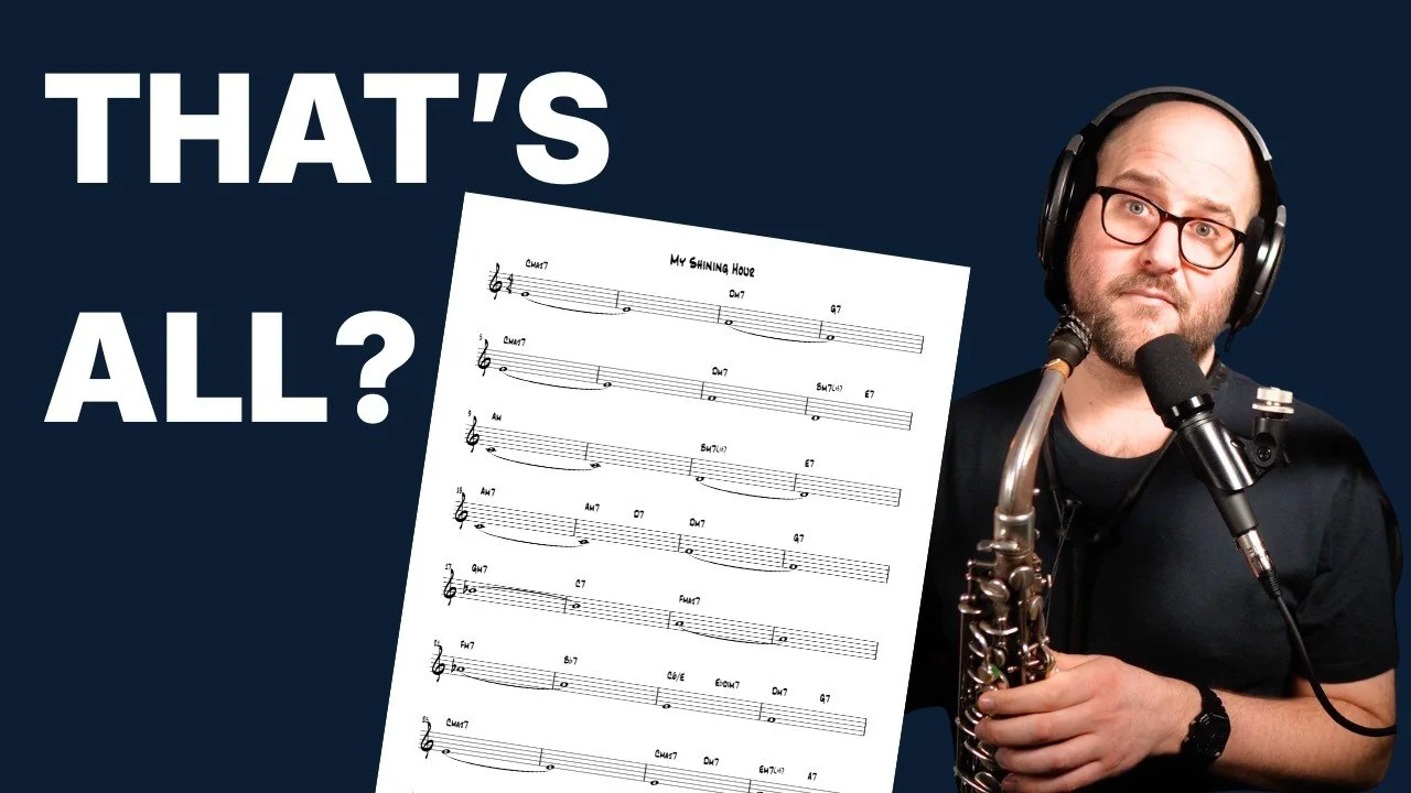 A man wearing glasses and headphones is holding a saxophone and sitting in front of a microphone, with sheet music titled 'My Shining Hour' beside him. The background is dark blue with large text that says 'THAT'S ALL?'.