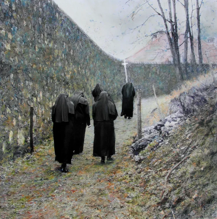 Four nuns walking on a dirt path between a stone wall on the left and a hill on the right, with leafless trees and a cloudy sky in the background.