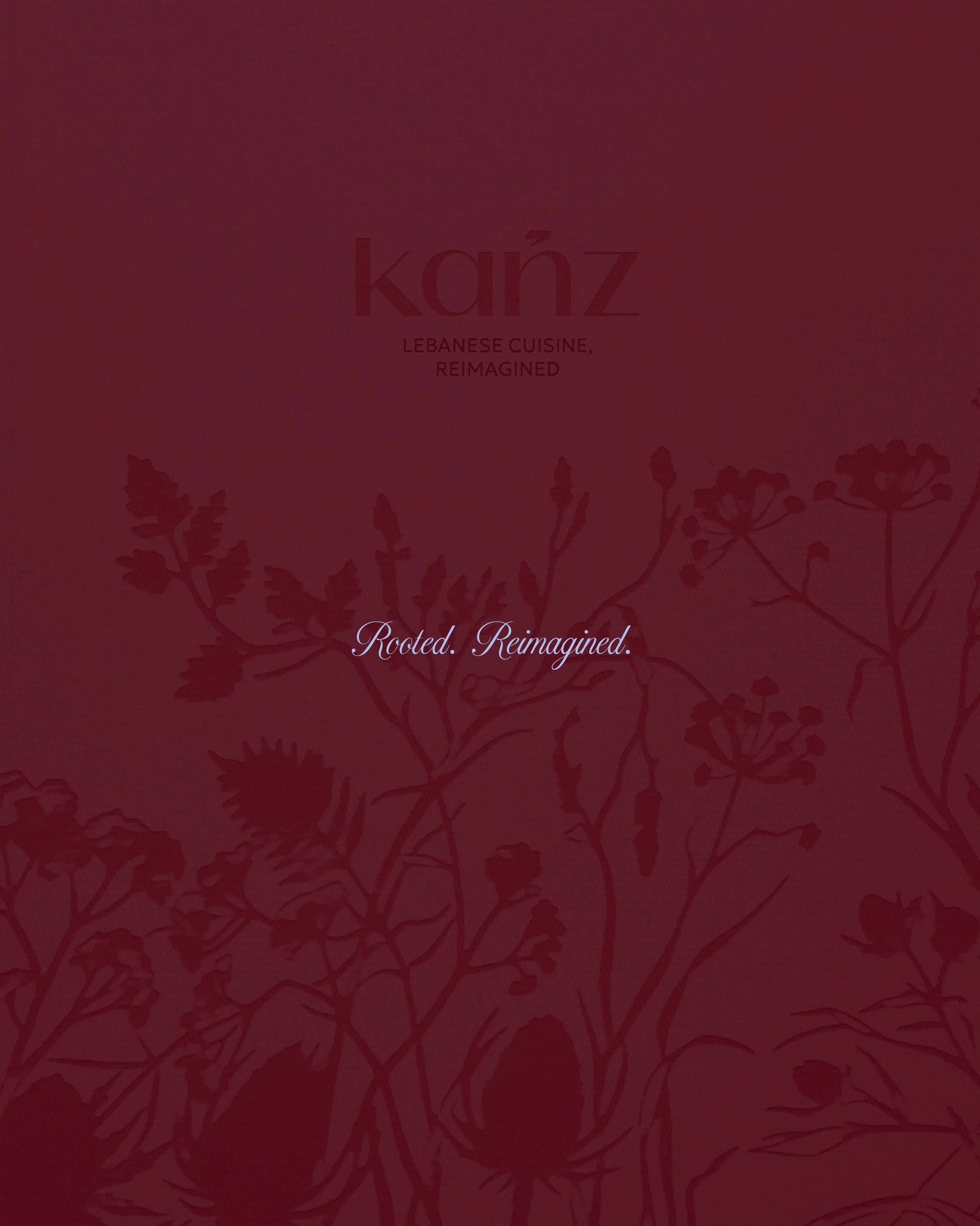 Cover of a cookbook titled 'Kanz: Lebanese Cuisine, Reimagined' with a dark red background and floral illustrations.