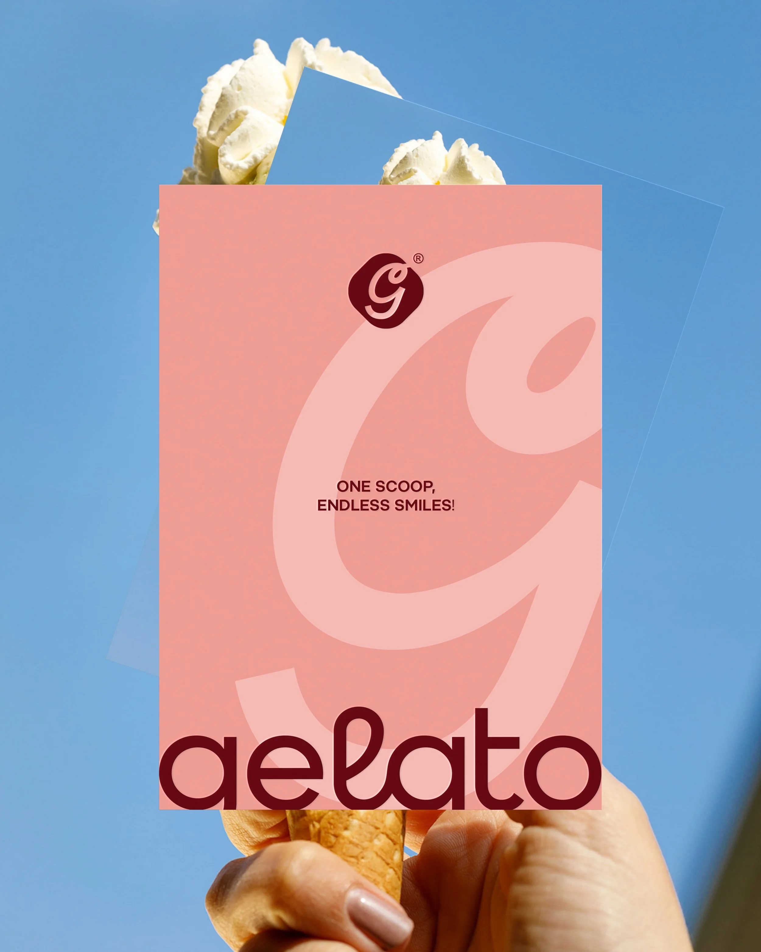 Close-up of a hand holding an ice cream cone with a pink card that has a logo and text, with a blue sky background.