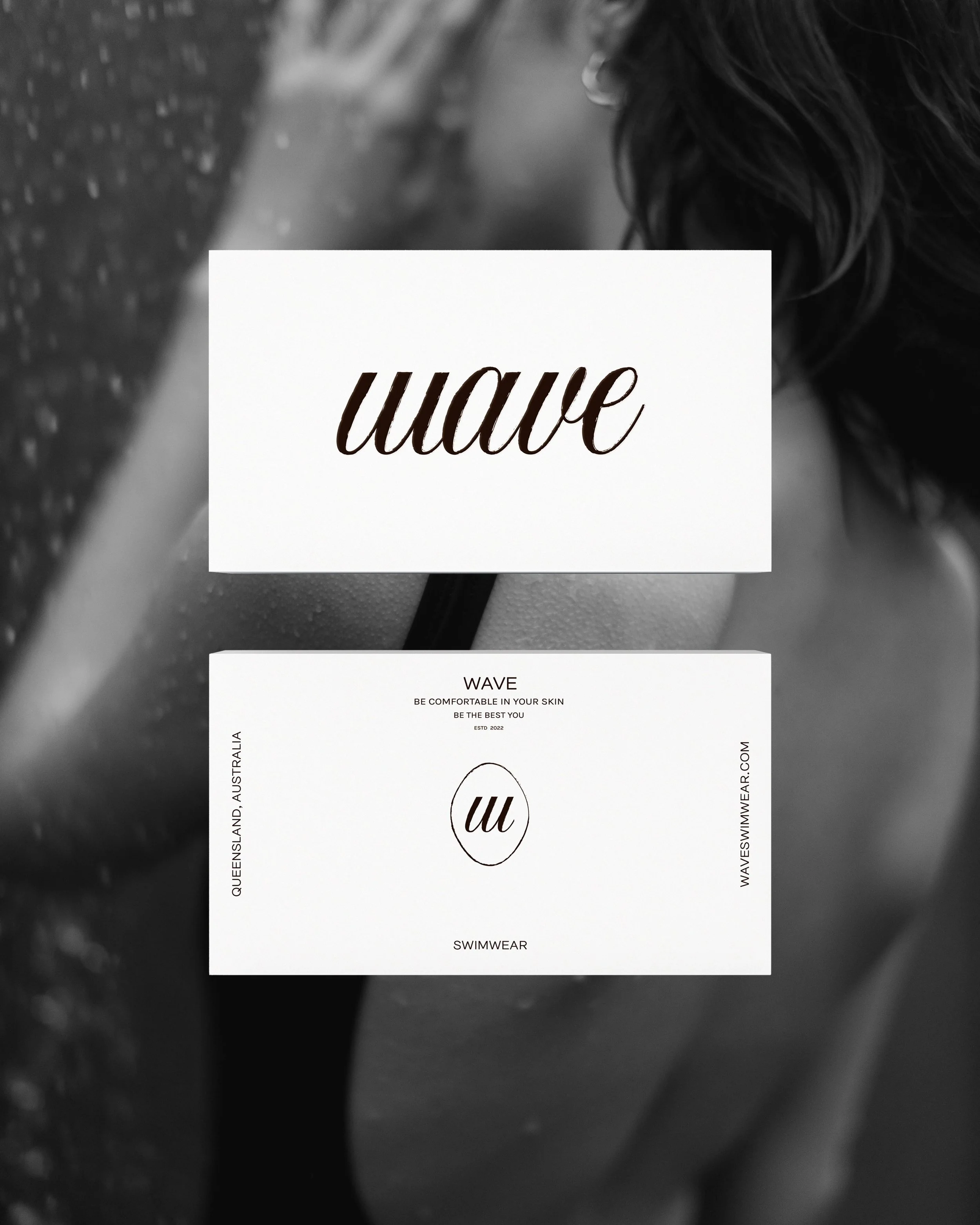 Close-up of a person with long, wet hair, with black and white overlay and branding text for a swimwear website.