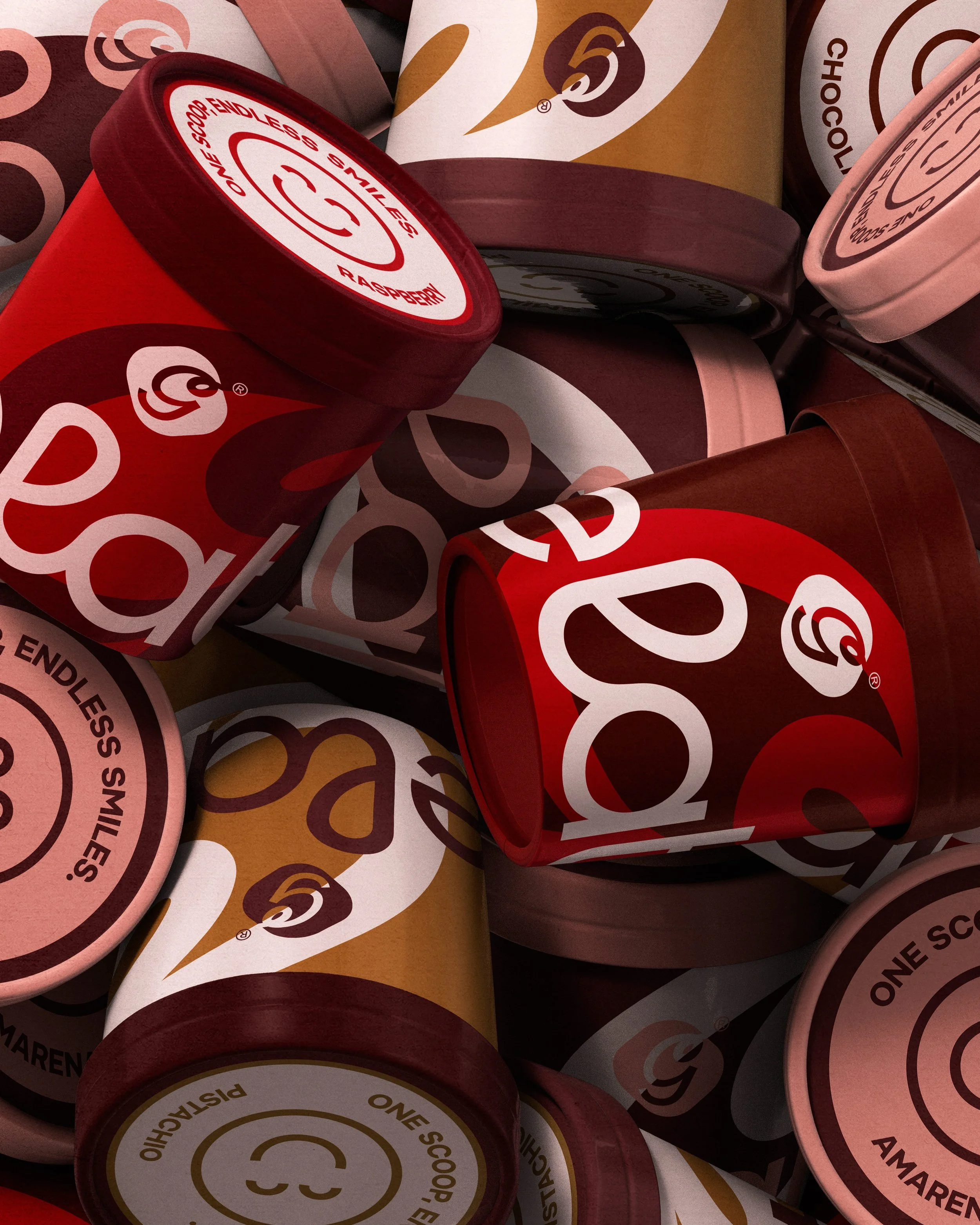 Close-up of several stacked rolls of red and pink wrapping paper with the品牌 logo and text printed on them.
