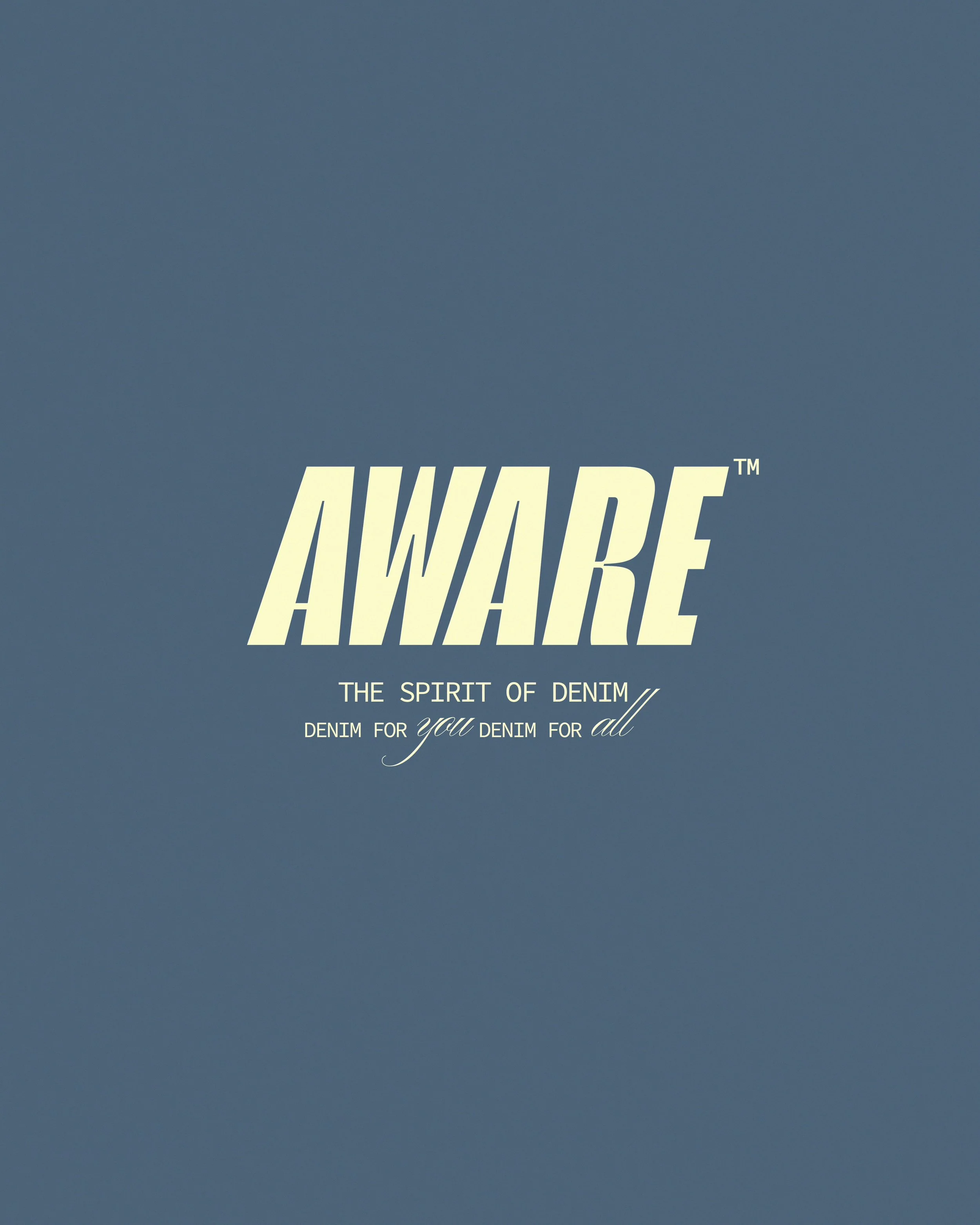 A close-up of denim fabric with the word 'AWARE' written in large, white, bold letters, and additional text below about denim and the spirit of denim.