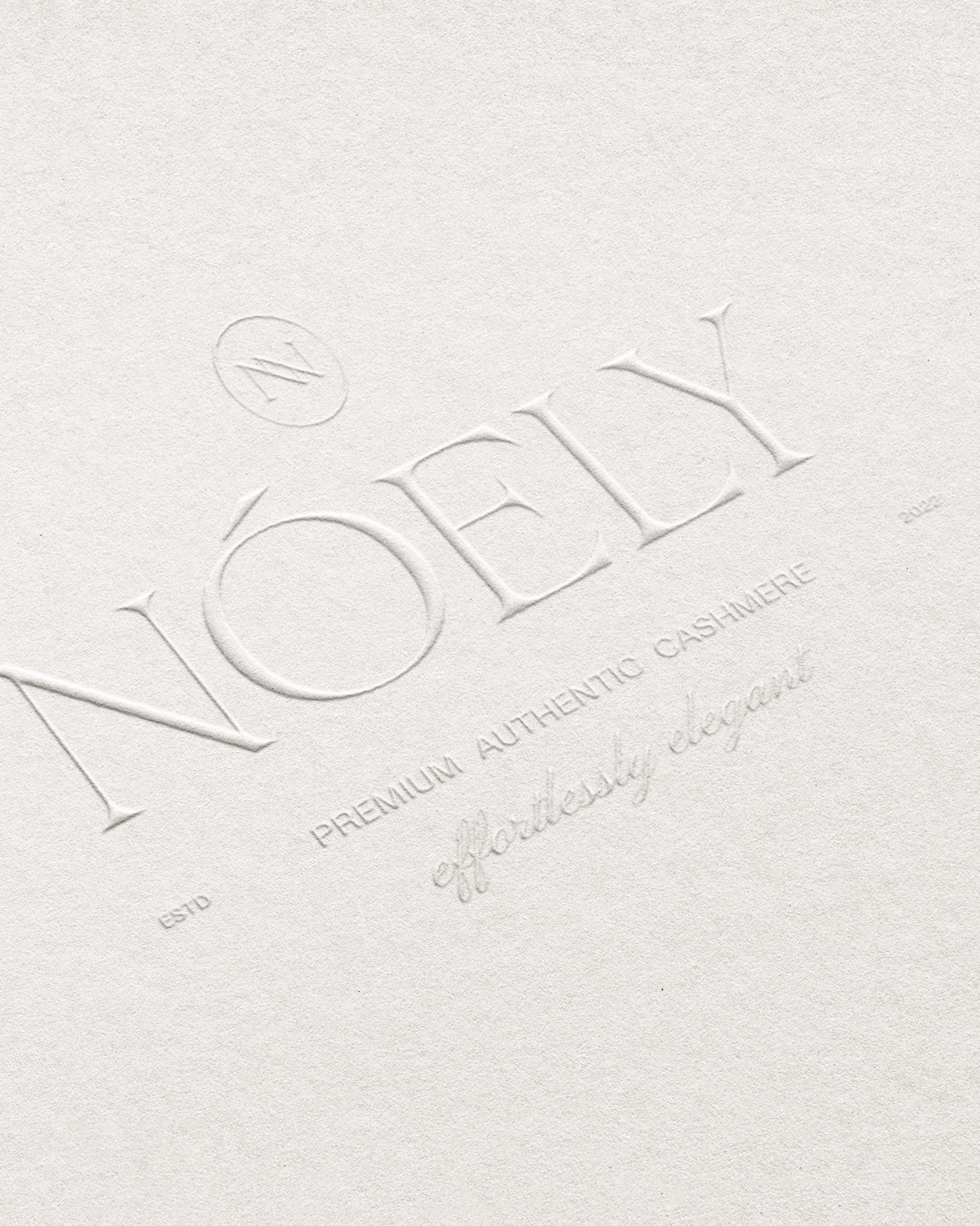 Close-up of embossed text on textured paper that reads 'THE'. 