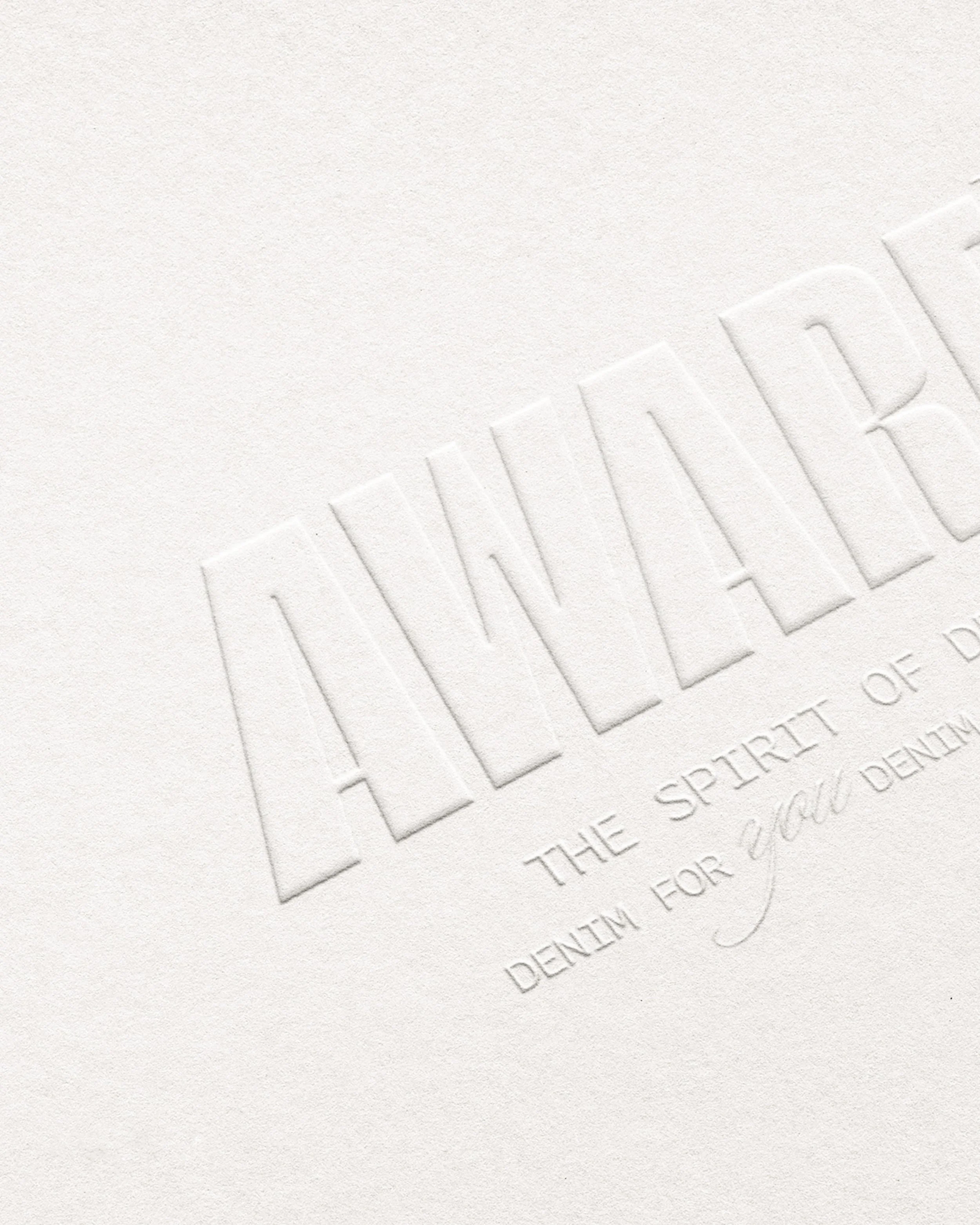 Close-up of embossed text on white paper reading "THE SPIRIT OF DENTAL" and other partially visible words.