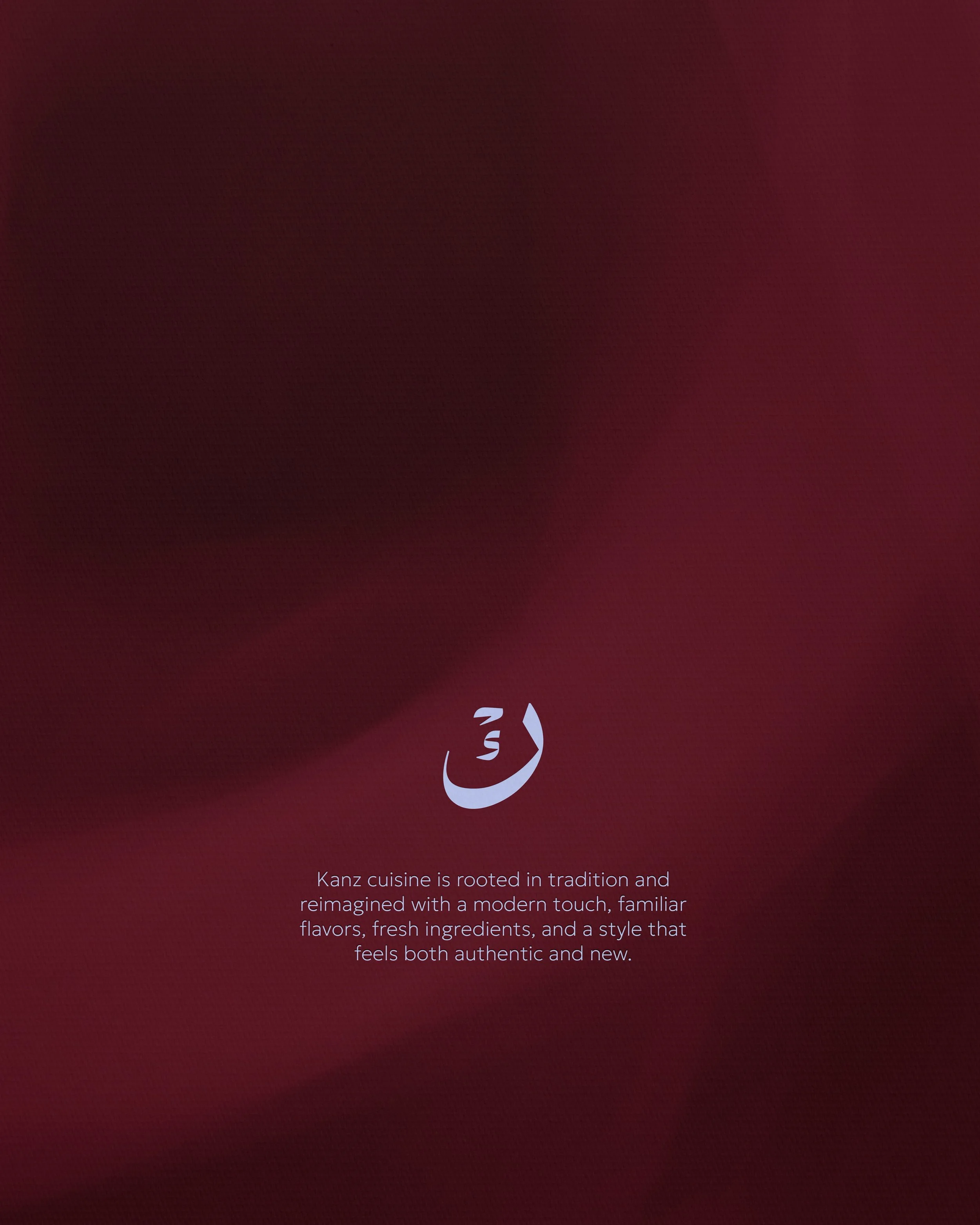 A screen with a maroon background featuring a white minimalist line drawing of a smiling face and some text about Kanz cuisine.