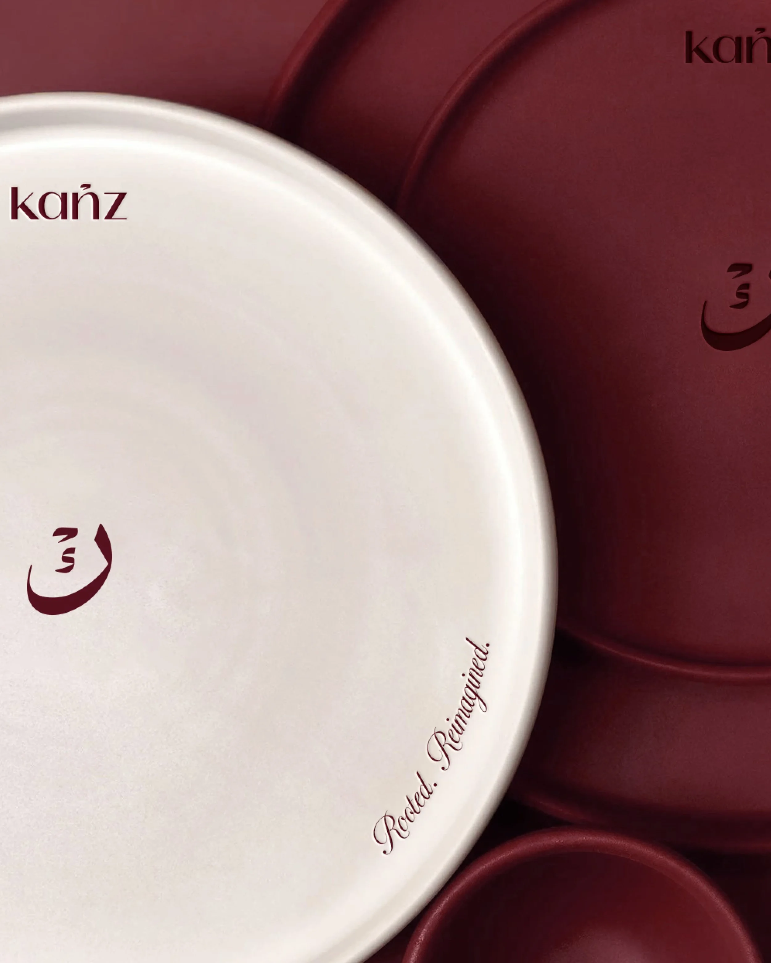 Close-up of heart-shaped boxes of chocolates, with the word 'kaíz' printed on two of them, and part of a phrase that appears to be 'Raíces...' in elegant cursive font.
