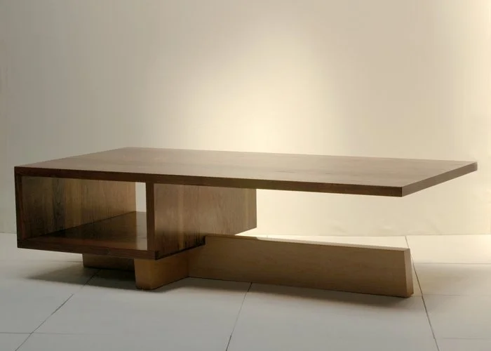 Modern wooden coffee table with a rectangular top and geometric base design.