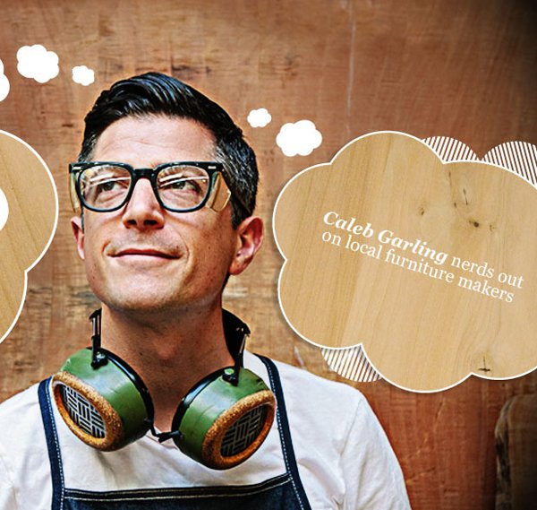 A man with glasses and a white shirt wearing green and brown headphones around his neck, standing in front of a wooden background with a cloud-shaped sign that reads, "Caleb Garling nerds out on local furniture makers."