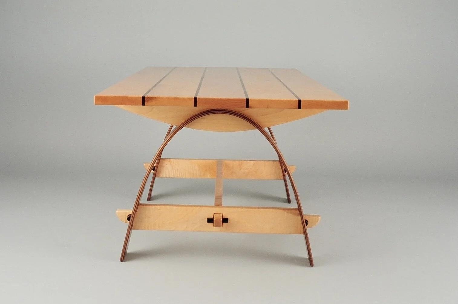 Wooden picnic table with a foldable metal frame and a light-colored wooden tabletop against a plain background.