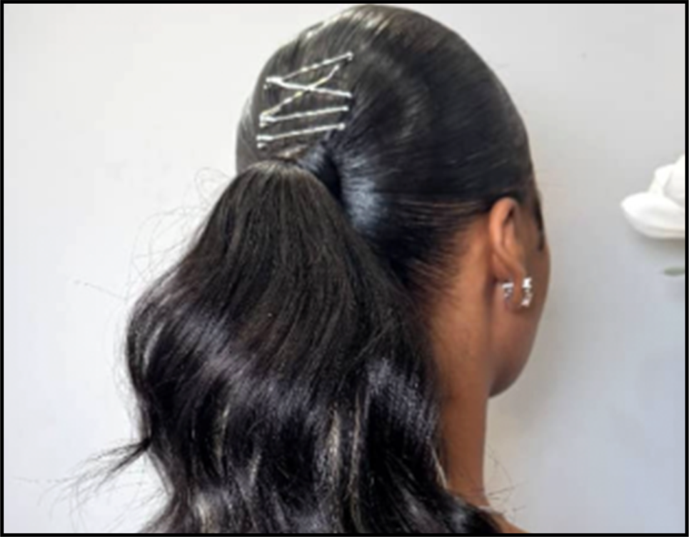 Back of a woman with long, dark, shiny hair in a high ponytail secured with a hair tie, and hairpins in her hair.