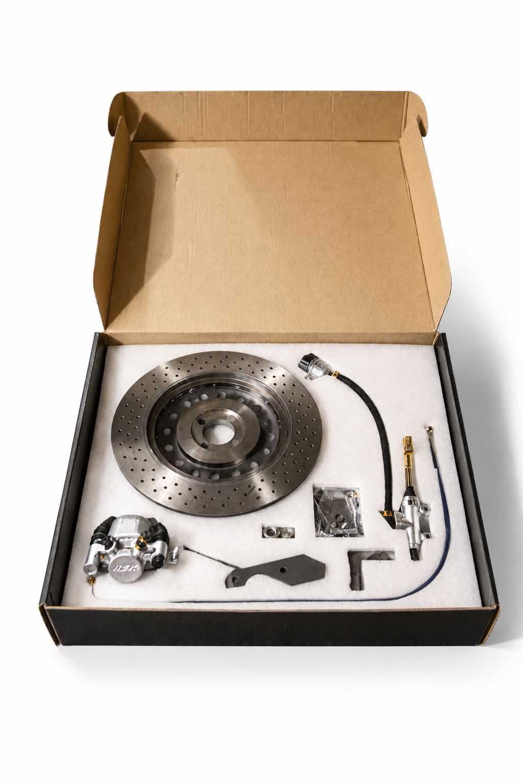 Unopened box with brake disc, caliper, and other automotive parts inside.