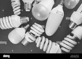 A collection of various types of light bulbs, including incandescent and spiral-shaped energy-saving bulbs.