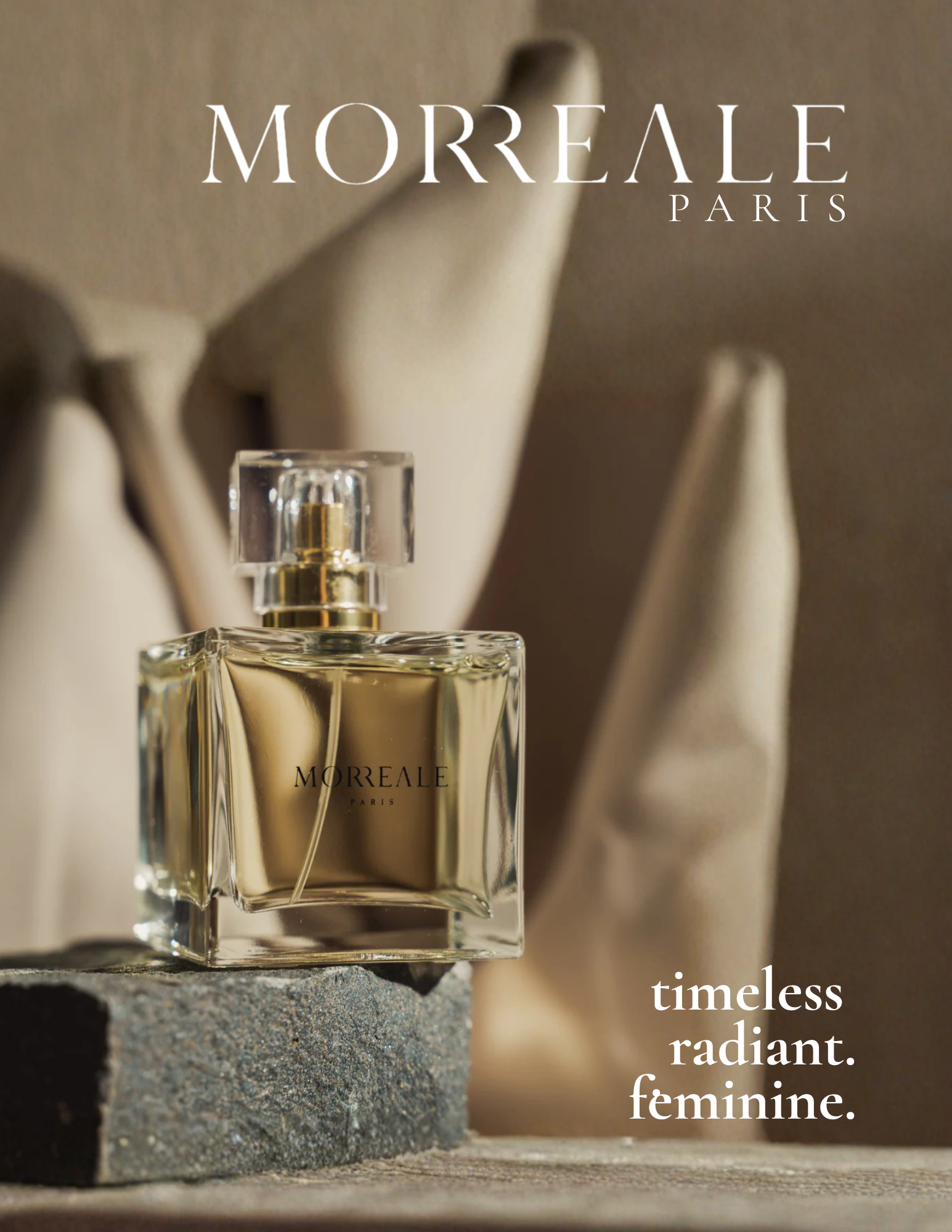 A perfume bottle labeled "Morreale Paris" is in foreground with a blurred background of white ceramic mannequins and a stone surface, featuring a quote about timeless, radiant femininity.