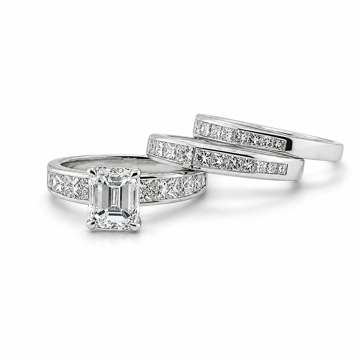 Platinum wedding set, featuring a large emerald-cut diamond and two matching wedding bands