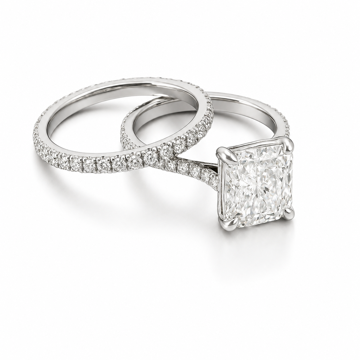 Platinum wedding set. Radiant cut diamond center stone with diamond pave on the shank and matching pave band.