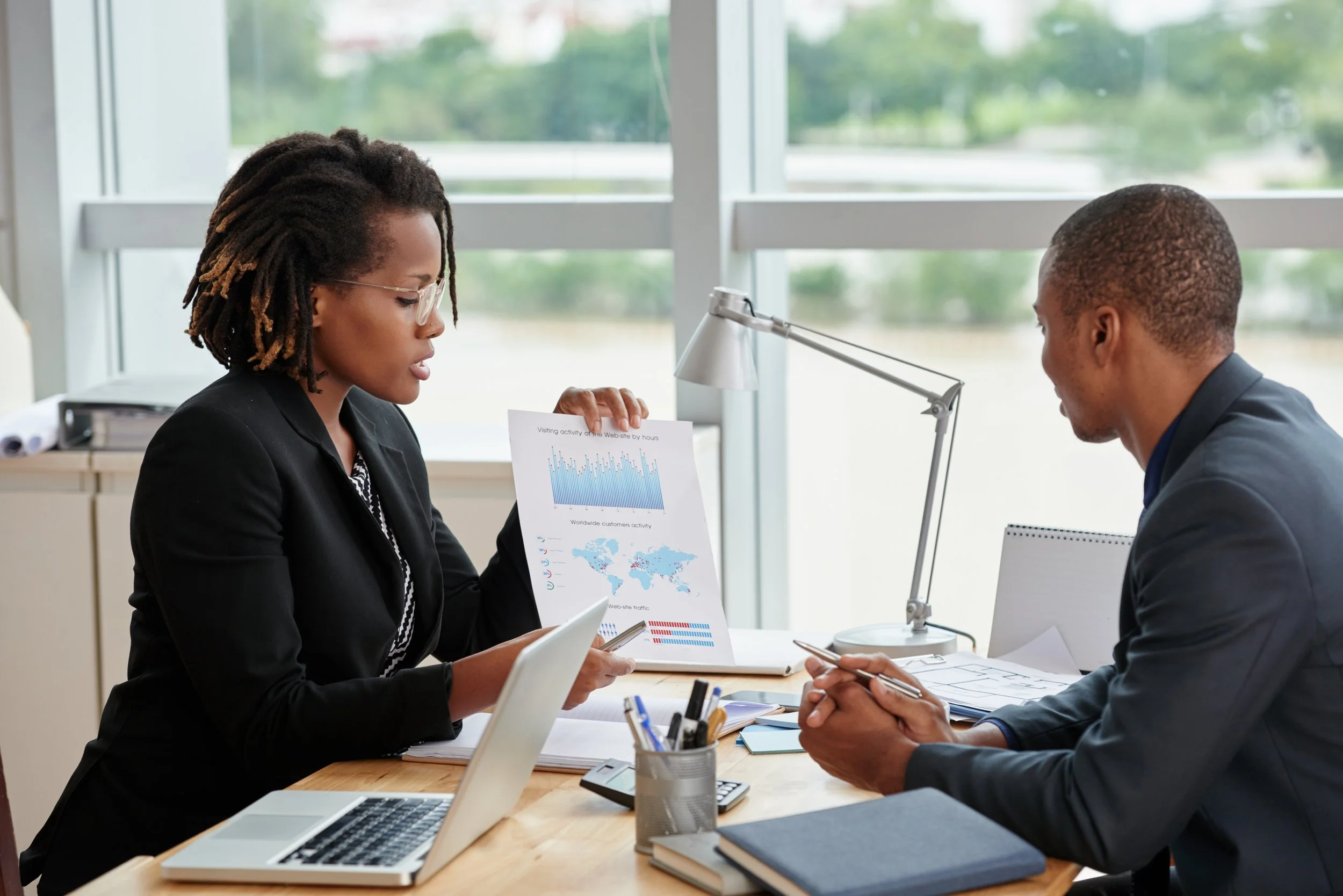 side-view-businesswoman-showing-analytical-charts-her-male-coworker.jpg
