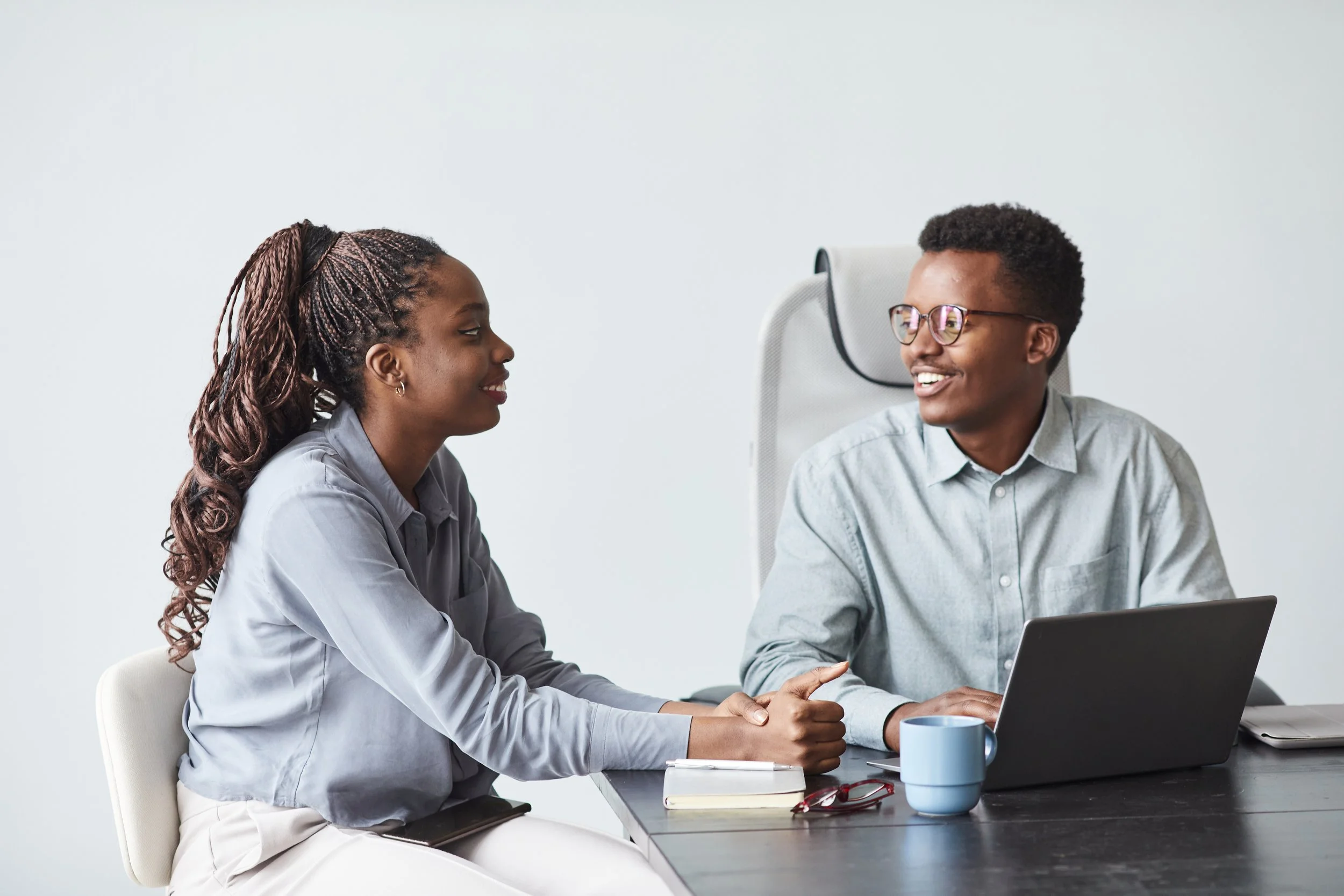 minimal-portrait-two-young-african-american-colleagues-collaborating-project-smiling-while-using-laptop-together-office-copy-space.jpg