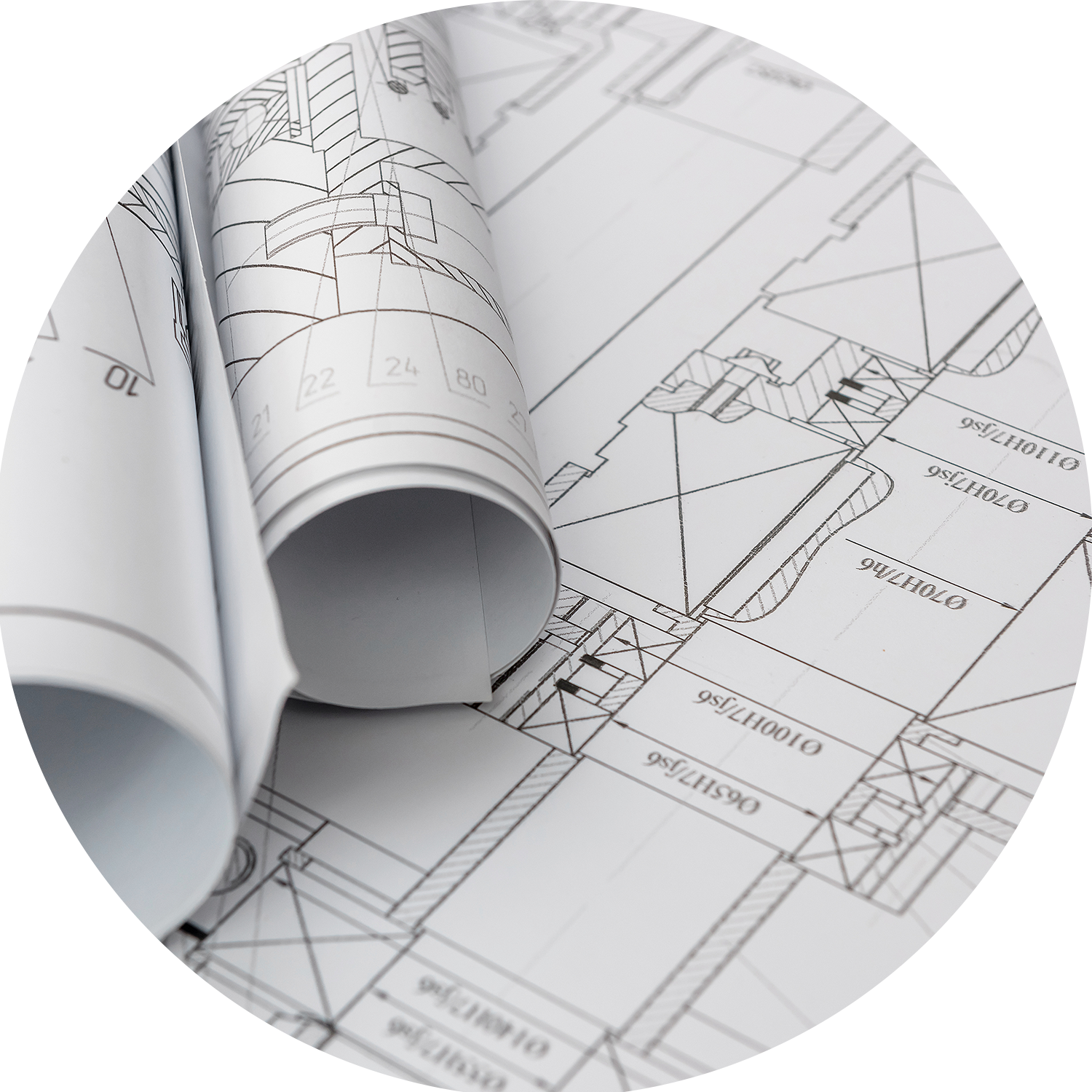 Blueprint architectural plans with rolled-up sections placed on detailed building floor plans.